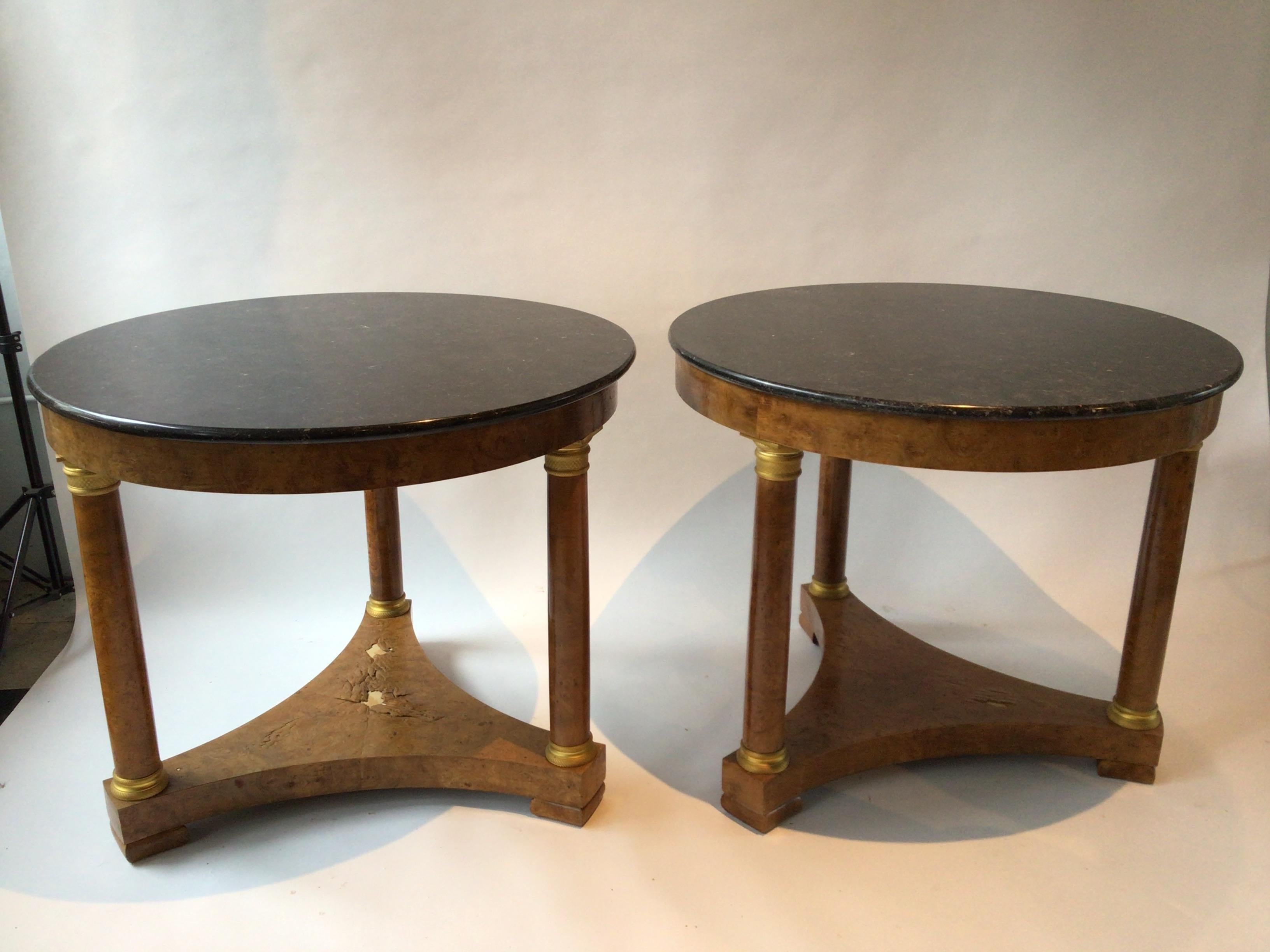 Pair of 1870s French Empire burl wood tables with marble tops. Dore bronze accents.
Some veneer missing, Marble tops are from the 1980s.