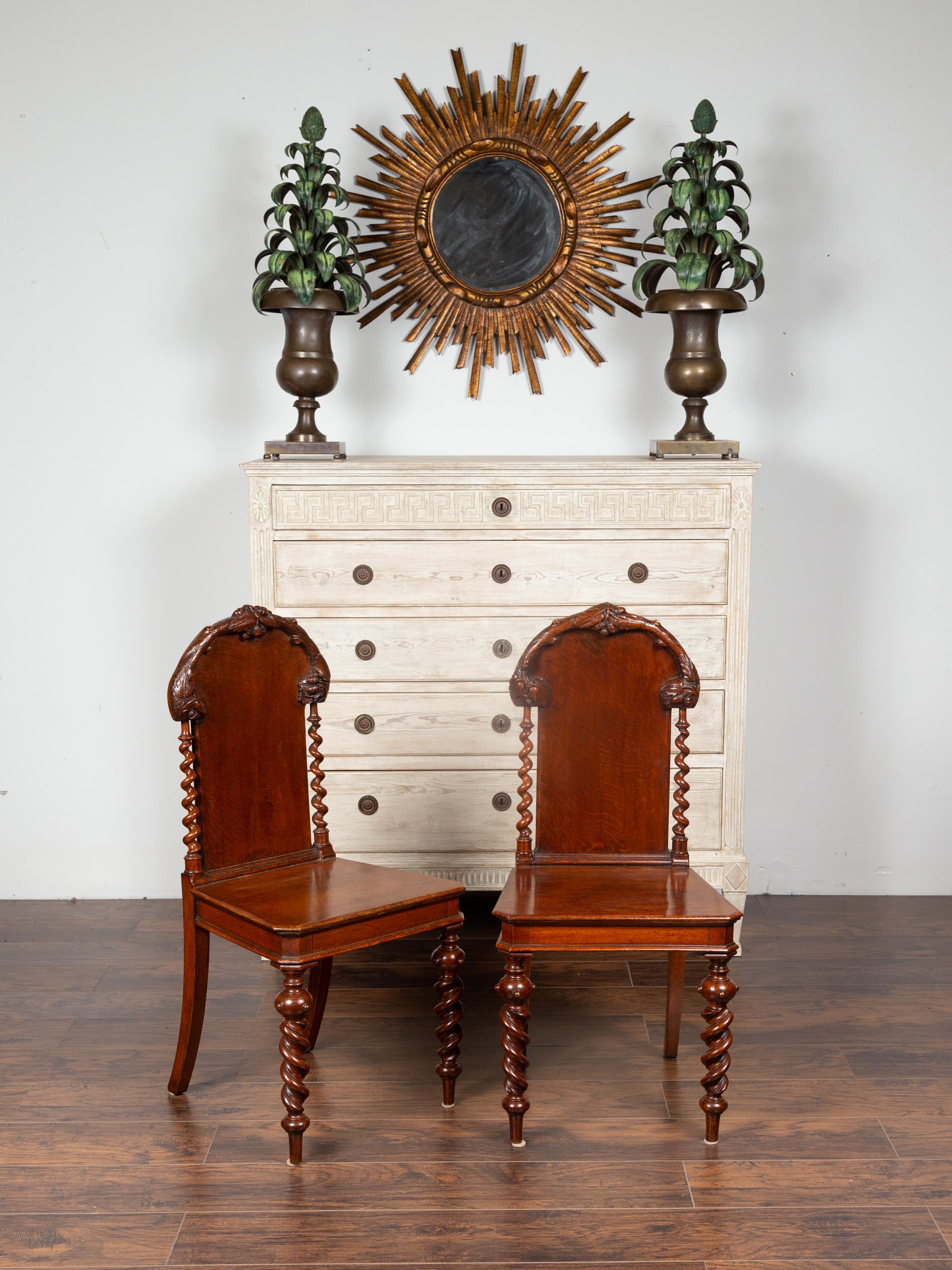 Carved Pair of 1880s English Barley Twist Oak Hall Chairs with Foliage and Acorn Motifs