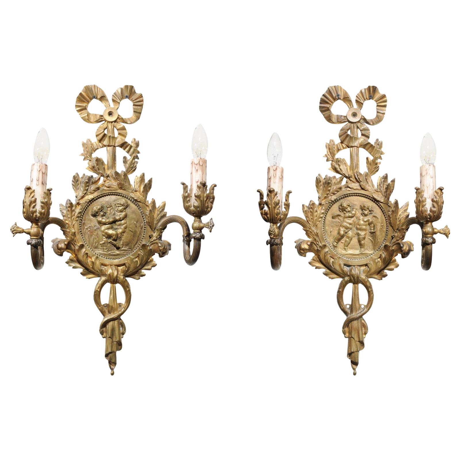 Pair of 1890s French Two-Light Brass Sconces with Ribbon, Cherubs and Satyrs For Sale