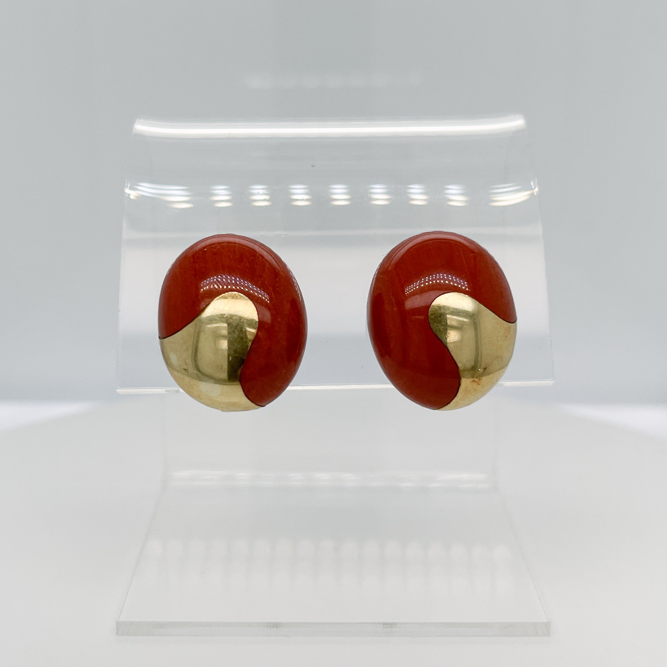 A fine pair of modern Angela Cummings attributed cabochon clip-on earrings.

With red jasper cabochons inlaid with 18K gold elements.

Purchased in a collection together with several signed Tiffany & Co. pairs of Angela Cummings earrings. We wonder