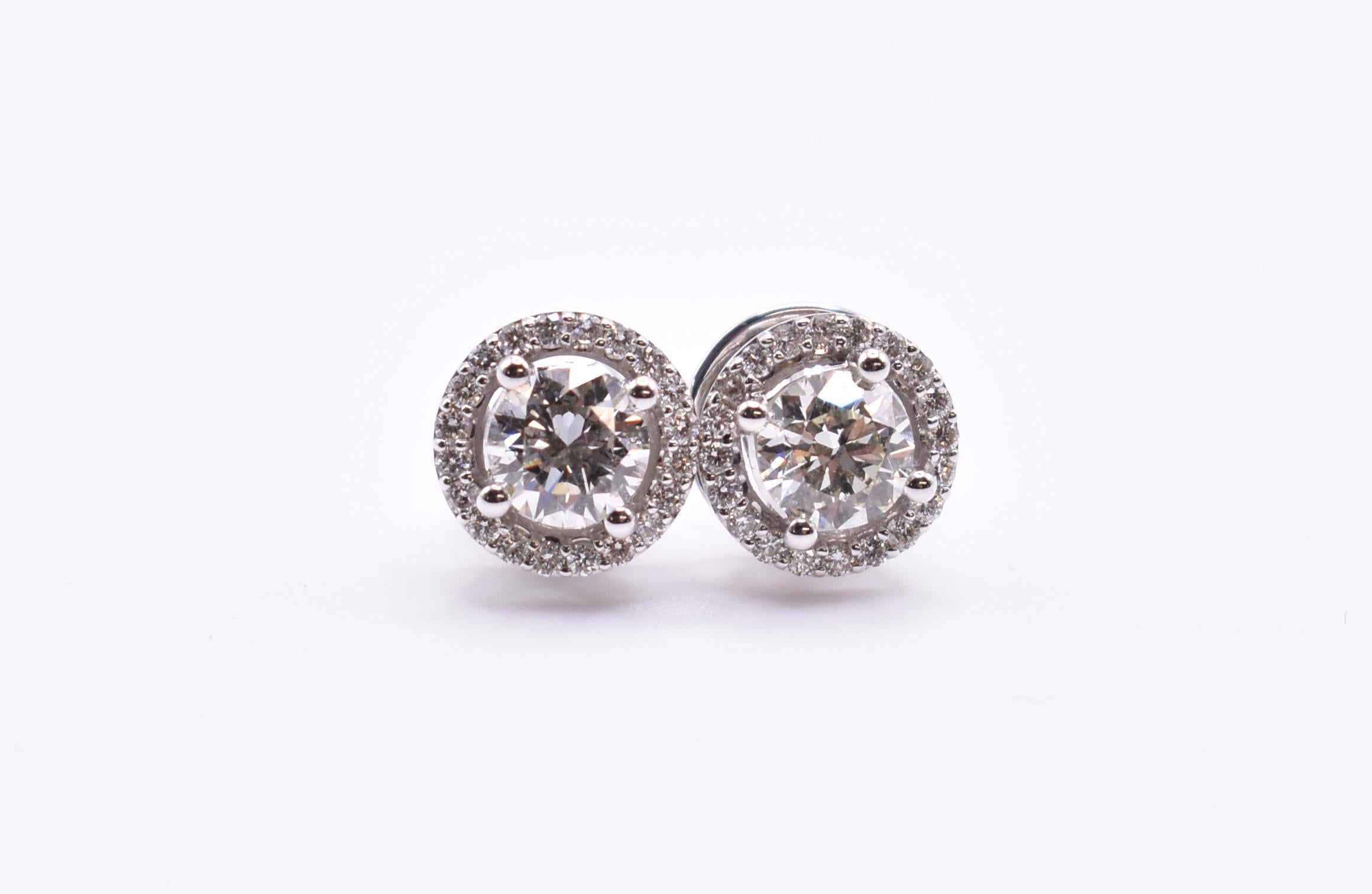 Brilliant Cut Pair of 18k White Gold 1.18 Carat Diamond Halo Stud Earrings For Sale