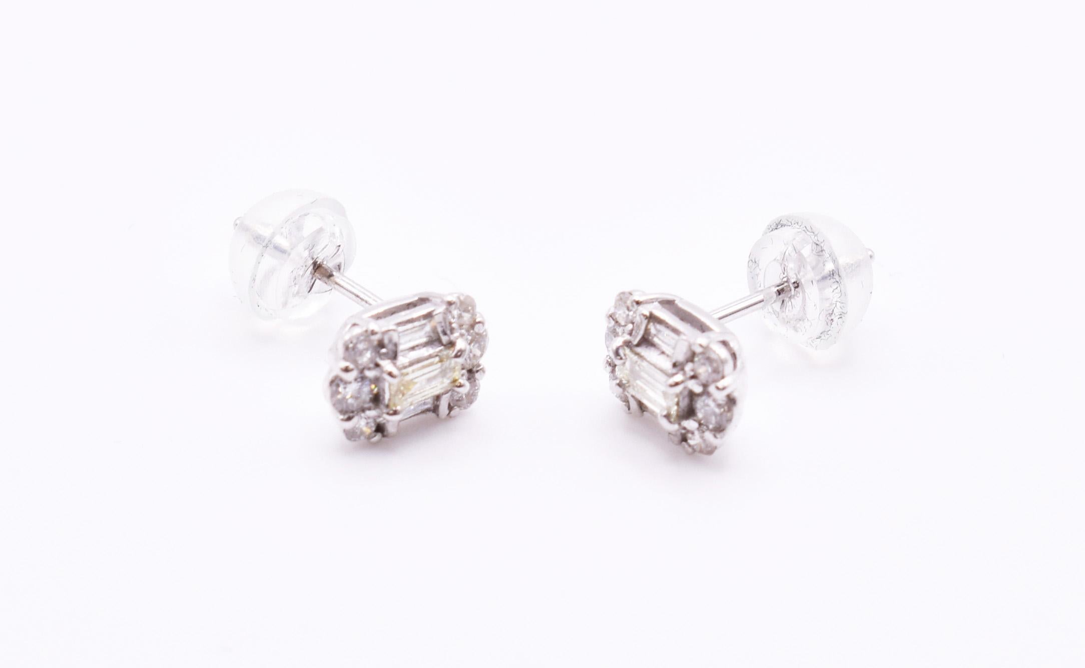 For sale is a nice pair of 18k white gold diamond earrings, each featuring three baguette cut diamonds, with a further 6 round cut diamonds. Diamonds = 0.42ct H colour SI clarity
