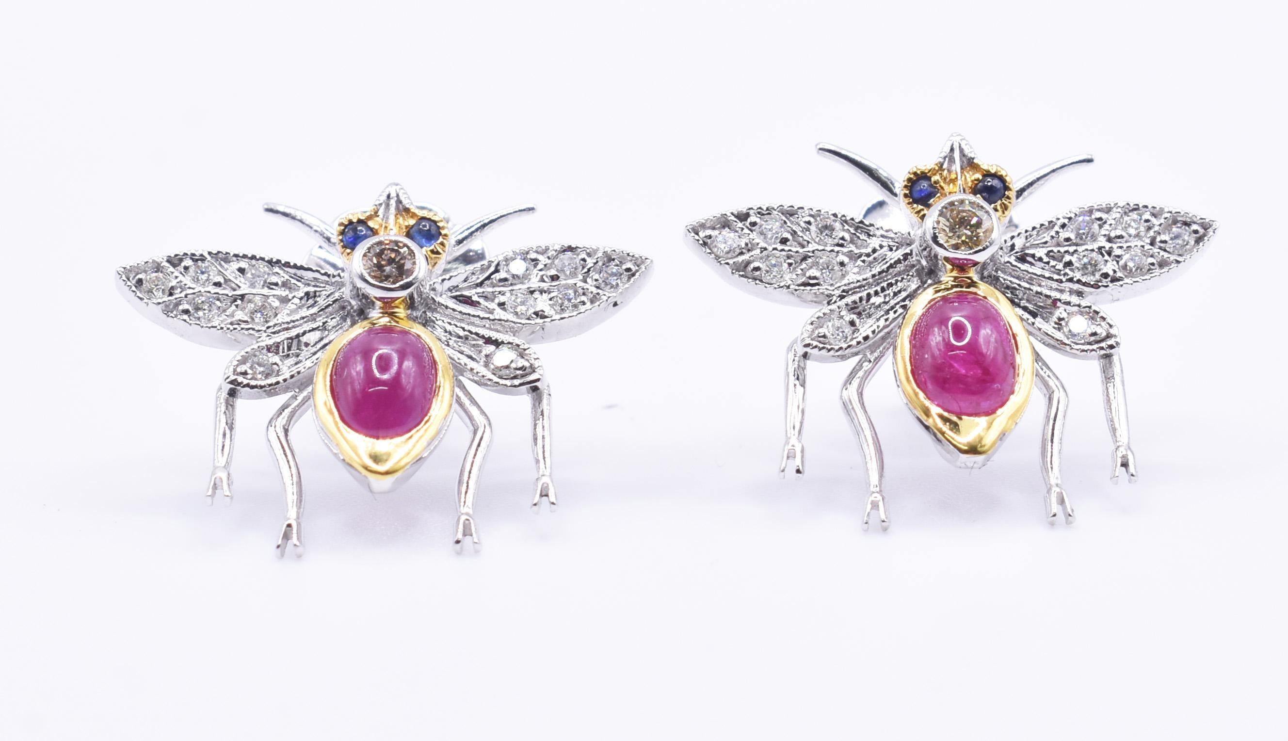 A sweet pair of 18k white and yellow hold ruby and diamond bug earrings, boasting 26 diamonds totalling 0.30cts, as well as superb cabochon Rubys. 

Metal: 18k White Gold
Total Carat Weight (Ruby): 1.25ct
Total Carat Weight (Diamond): 0.30ct