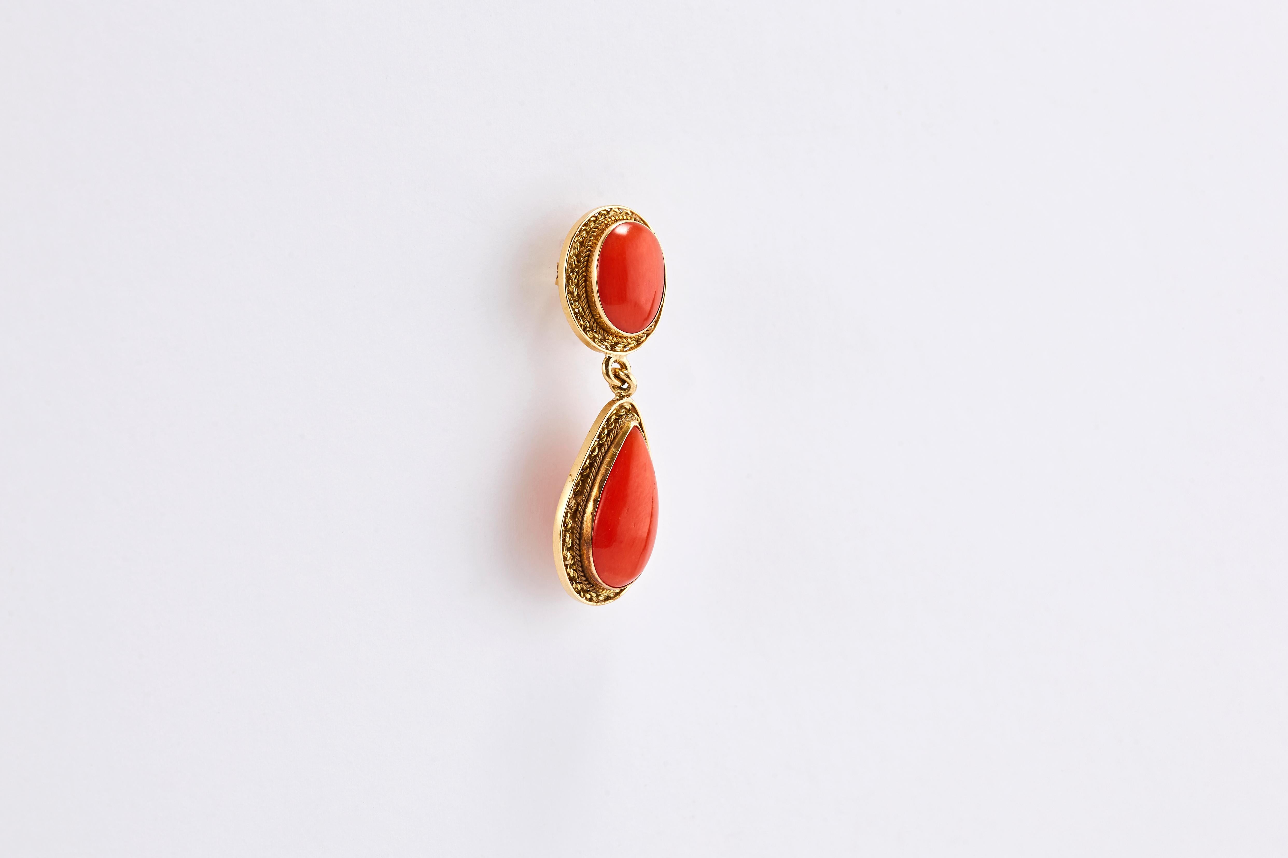 Pair of 18K Yellow Gold and Coral Drop Earrings 

Made in Italy in the 80s.
Beautiful coral gold earrings with an antique look. Each earring has 2 corals, an oval one on the top and a pear shape one on the part that drops.

Total weight: 6.05 grams.