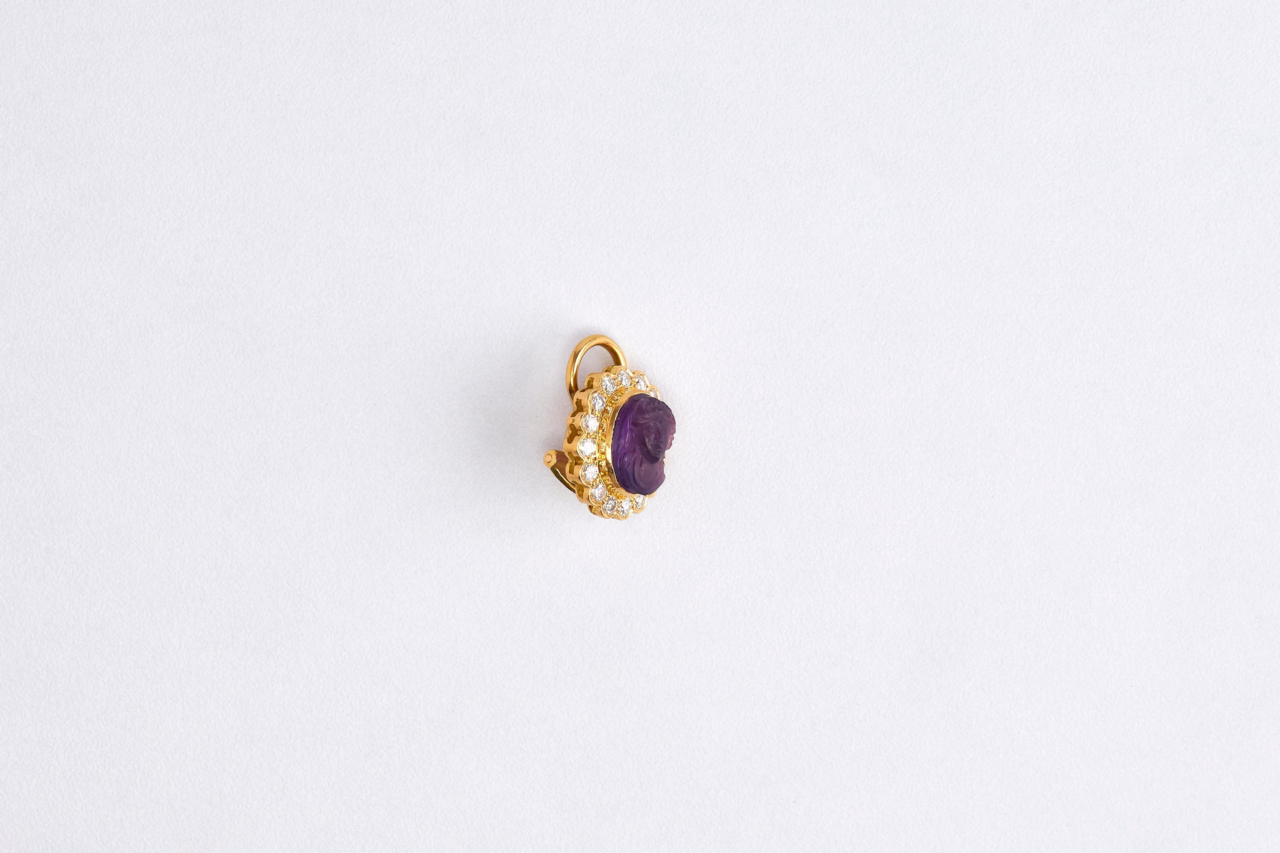 Pair of 18k Yellow Gold Diamond and Amethyst Earring

Gorgeous pair of earrings. Center stone is an Amethyst carved with a woman's face on it. 
Amethyst is surrounded by 1.20 G VVS1 round cut diamonds.
These earrings were made in France in the