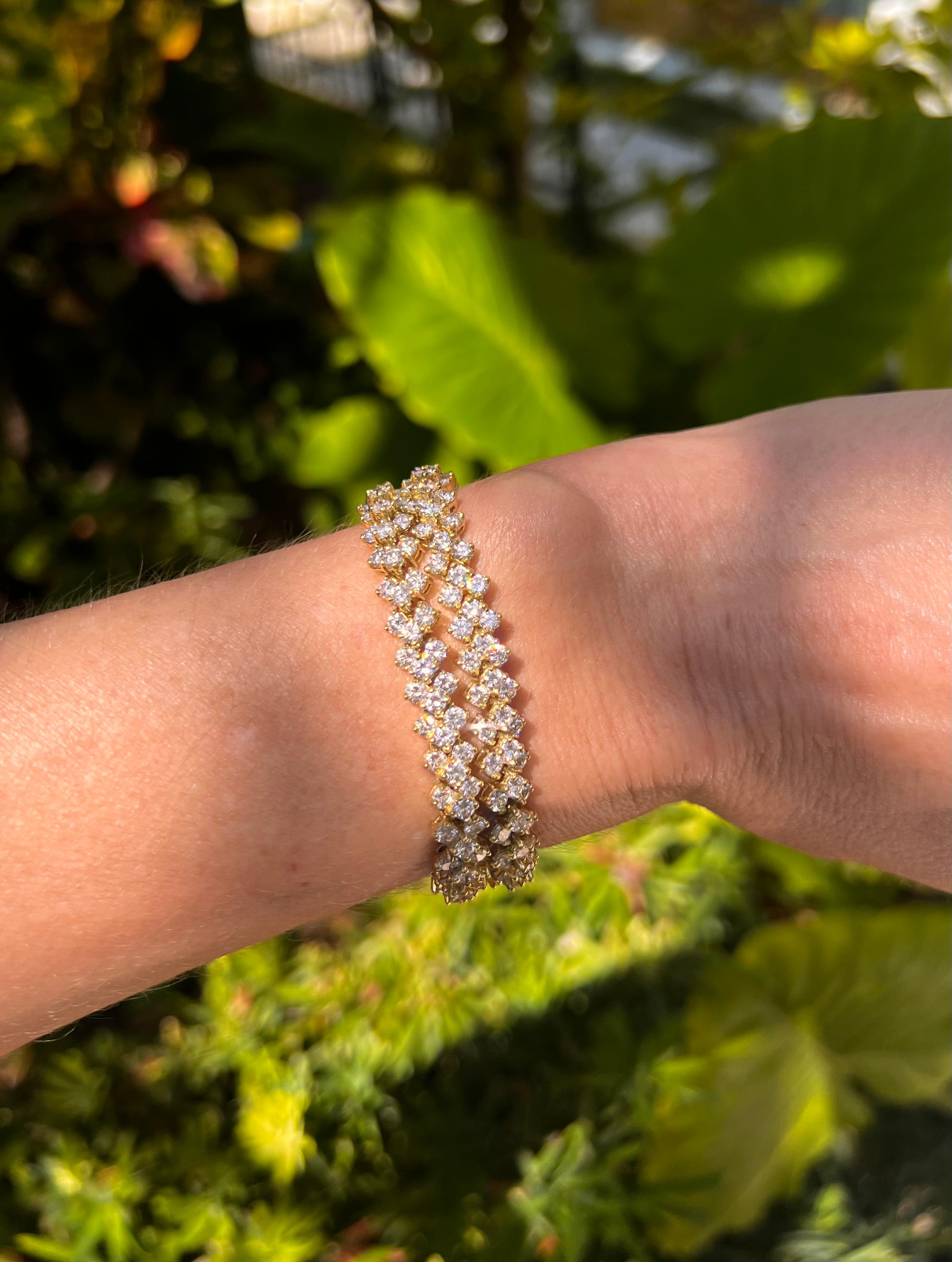 Pair of flexible diamond line bracelets in polished 18k yellow gold, each link accented by three round-cut diamonds.  Either bracelet features 108 diamonds weighing approximately 7.50 total carats (approximately 15 carats total weight for the pair).