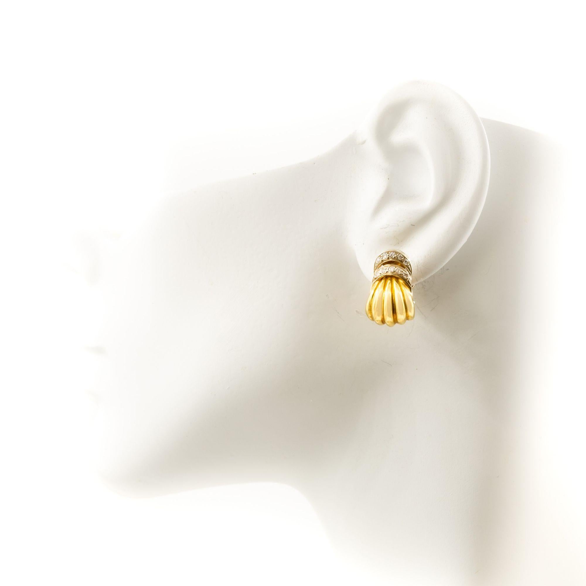 Pair of 18K Yellow Gold & Gemstone Swirl Earrings
Item # C104609

A beautiful pair of 18K yellow gold earrings, featuring a swirl design that gives them a dynamic and fluid appearance. The swirls are accented with a band of gemstones, creating a