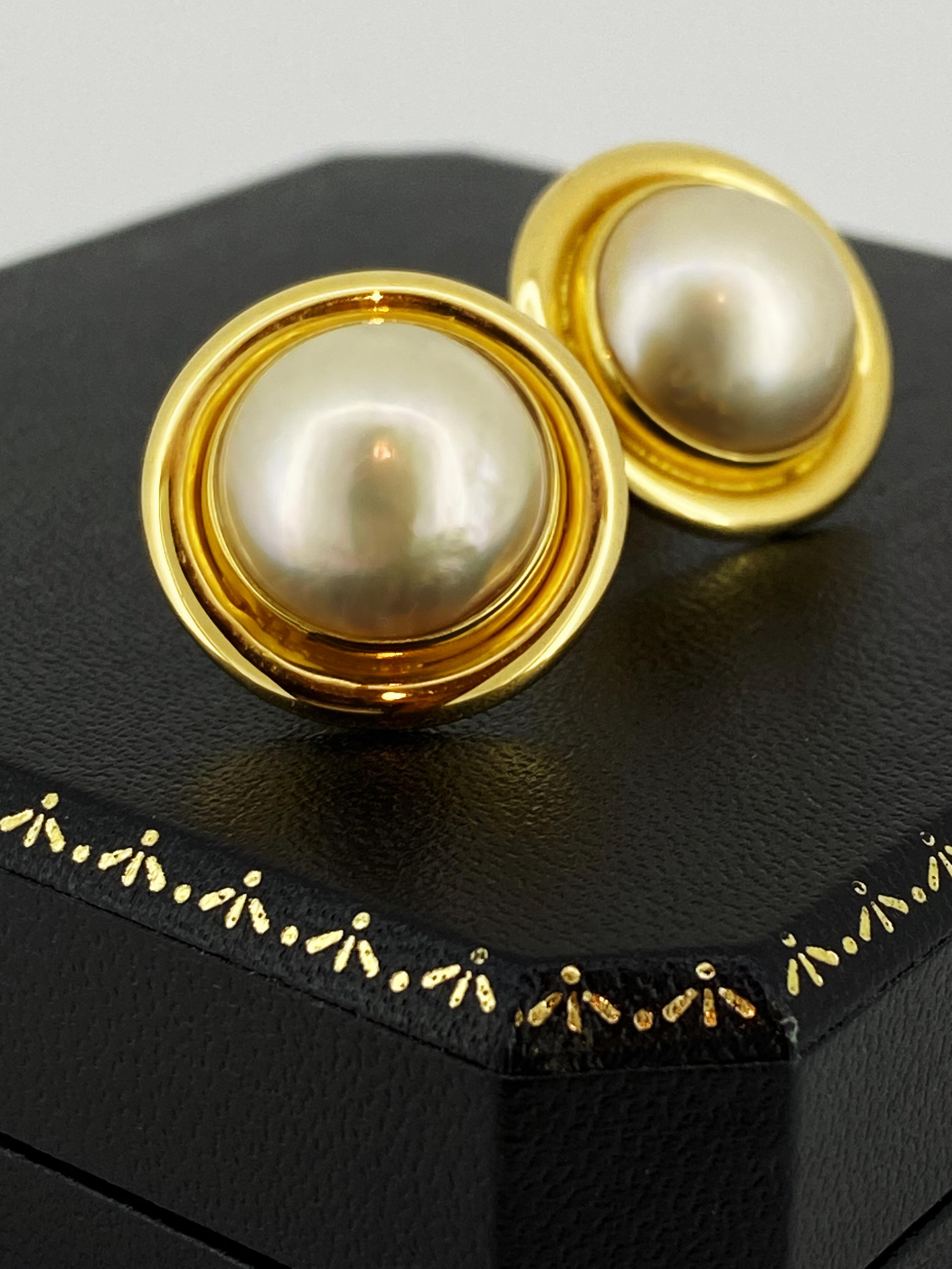 This delightful pair of Mabe Pearl Earrings 
feature a classical design, that is both very feminine & elegant

Meticulously crafted in 18K Yellow Gold, 
each earring features a Mabe Pearl of 15mm in diameter 
each of fine mirror-like lustre 
of
