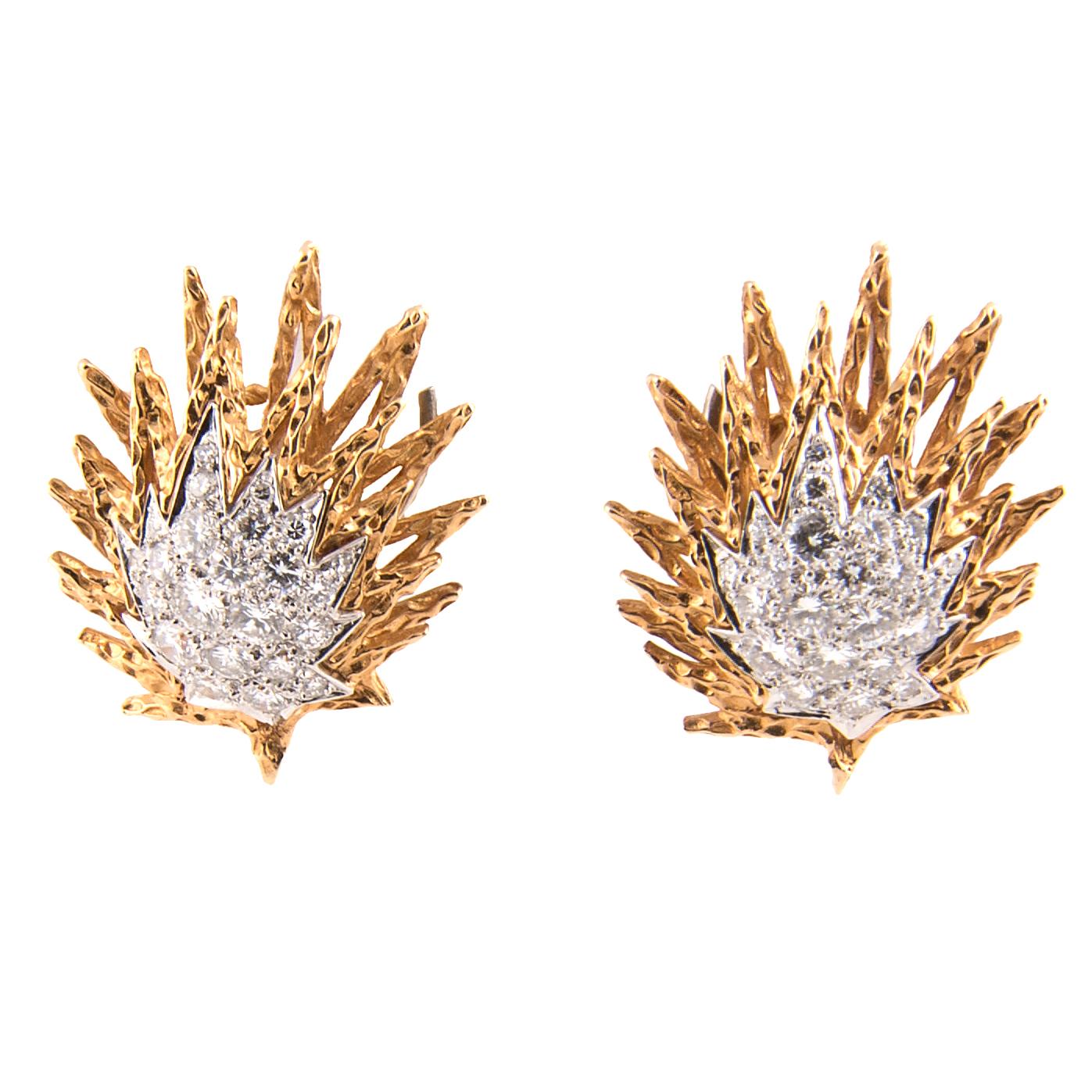 Pair of clip-on day-and-night earrings designed as stars with three smaller stars dangling below, textured 18k yellow gold and platinum with pavé set diamonds, approximately 4 cts, high colour. The articulated smaller stars give the earrings an