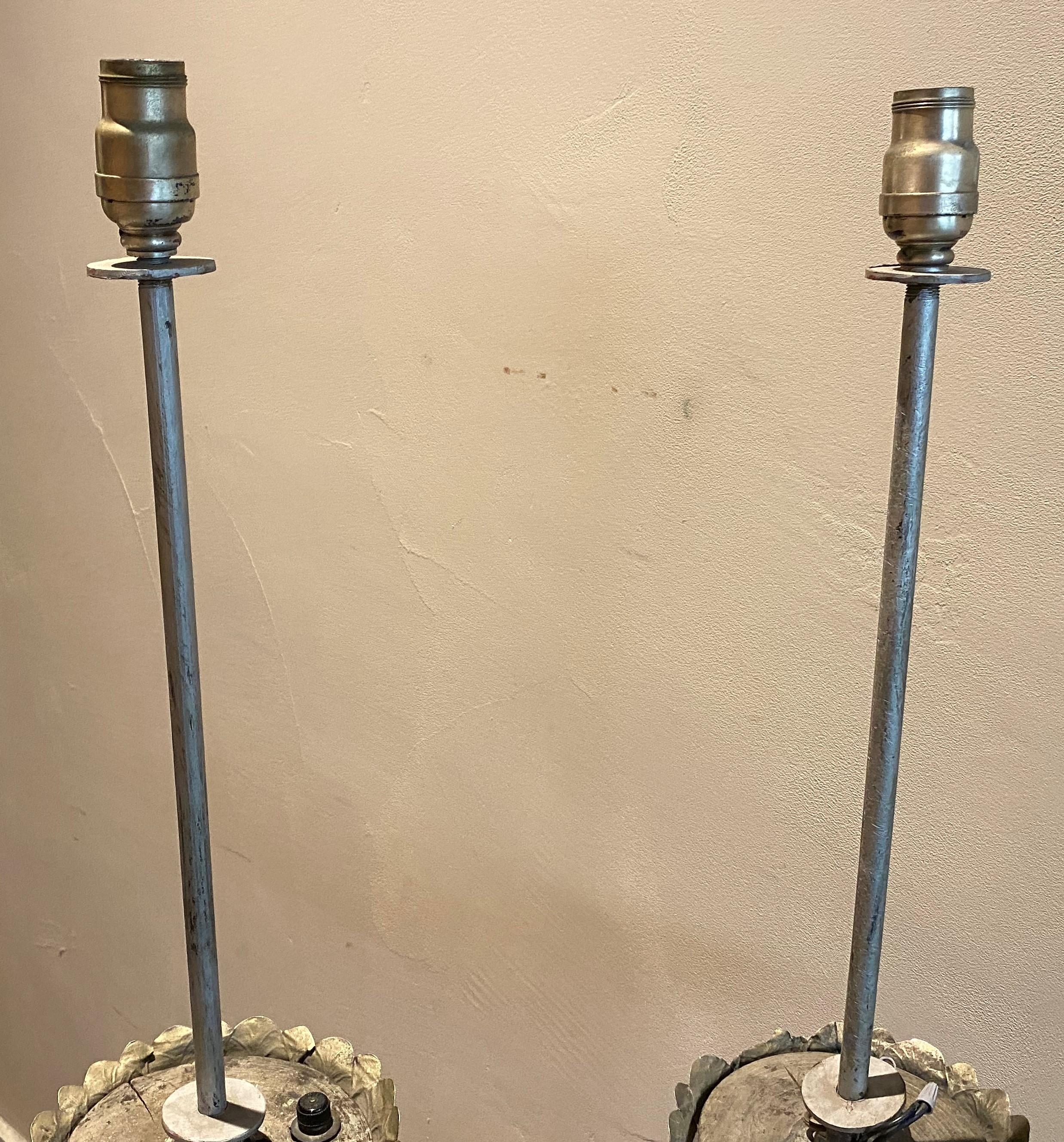A fine pair of Italian silvered metal altar sticks with tripod bases, dating to the late 18th or early 19th century, electrified and modified into floor lamps.  Good overall condition, with some metal bends, splits, and other imperfections and wear