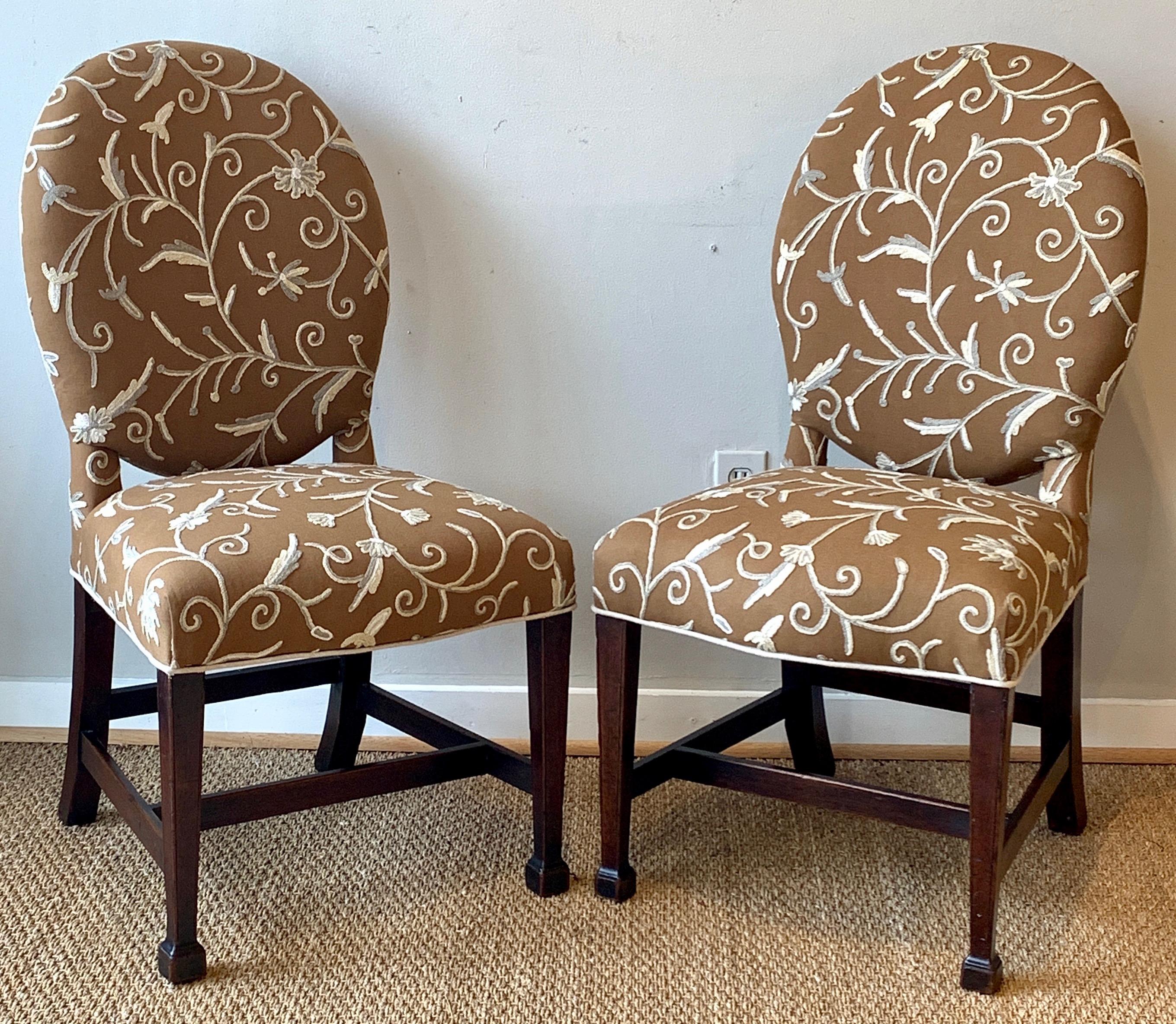 A very handsome pair of English George III side chairs with square tapering mahogany legs recently upholstered in a brown, cream and gray crewel fabric.