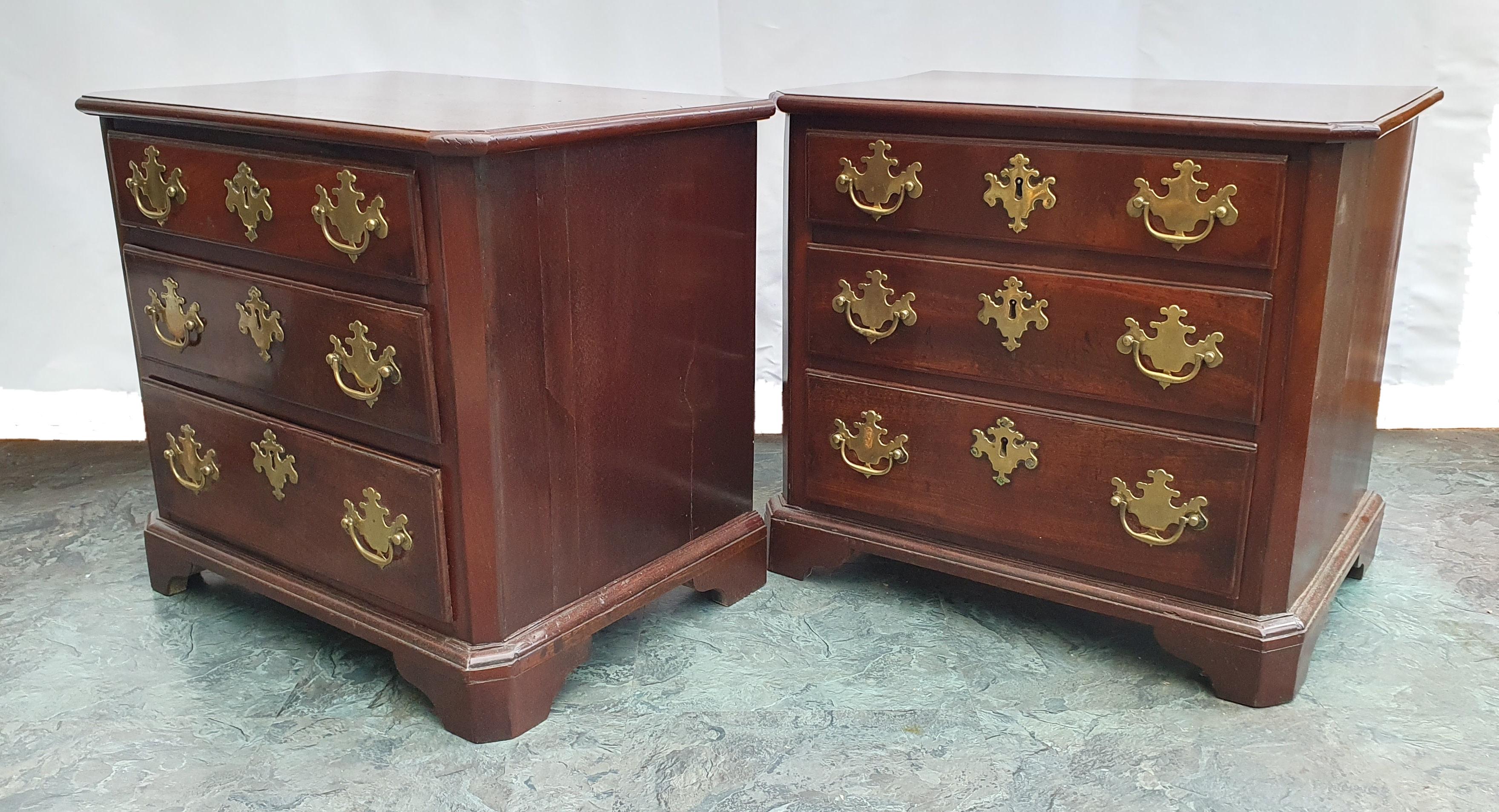 This lovely pair of 18th Century mahogany chests feature 3 graduating drawers with ornate brass handles and escutcheons. They also have oak drawer linings, which were prevalent in better quality furniture at that time. The feet of the chests were