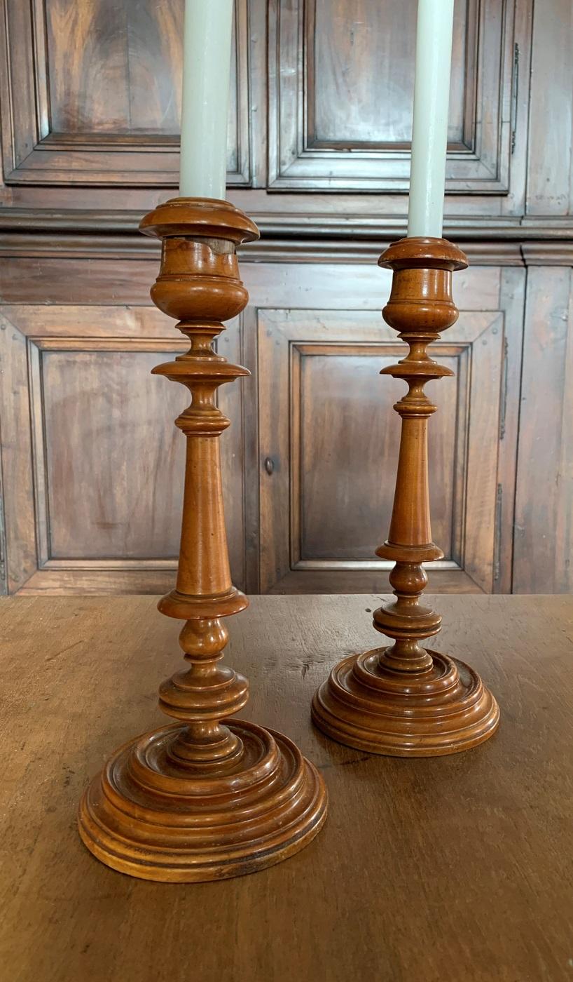 A pair of large 18th century French boxwood veneered candlesticks. Beautifully and delicately turned. The top bobbins, as original, removable for cleaning purposes. One of them has a small piece of veneer missing at the top. As we use them on a