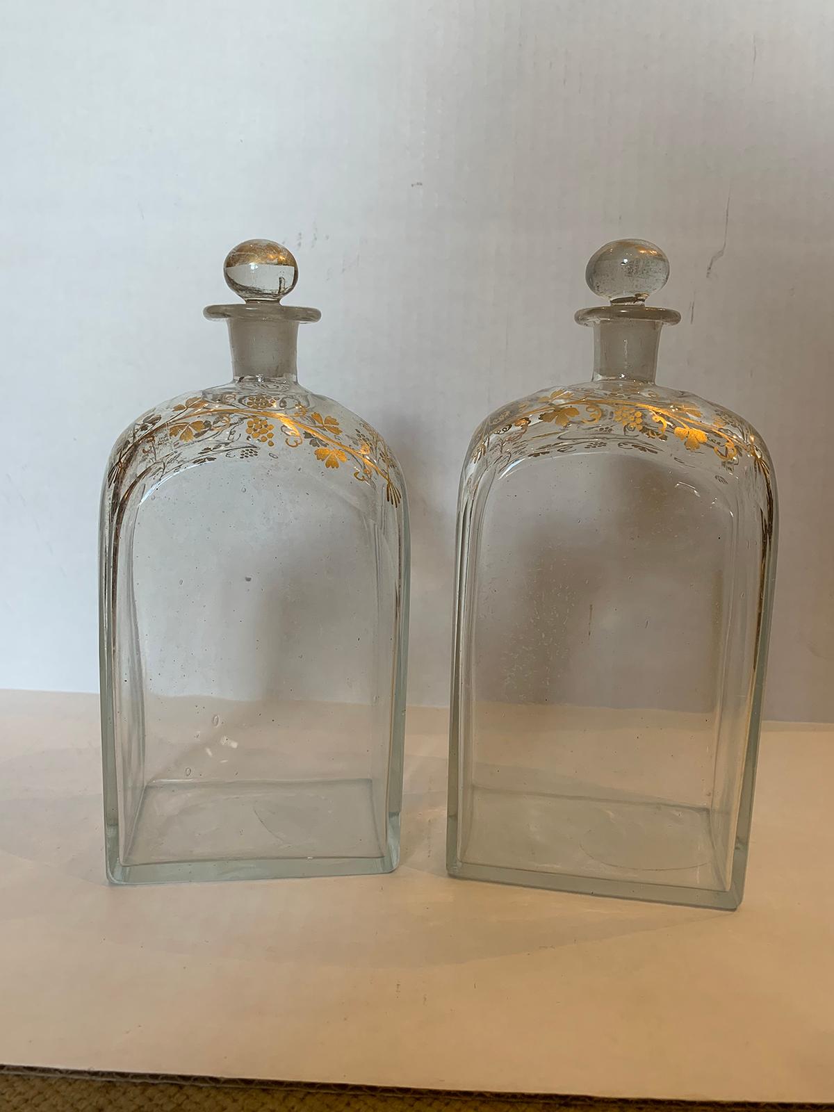 Pair of 18th century American glass decanters with gilt details.