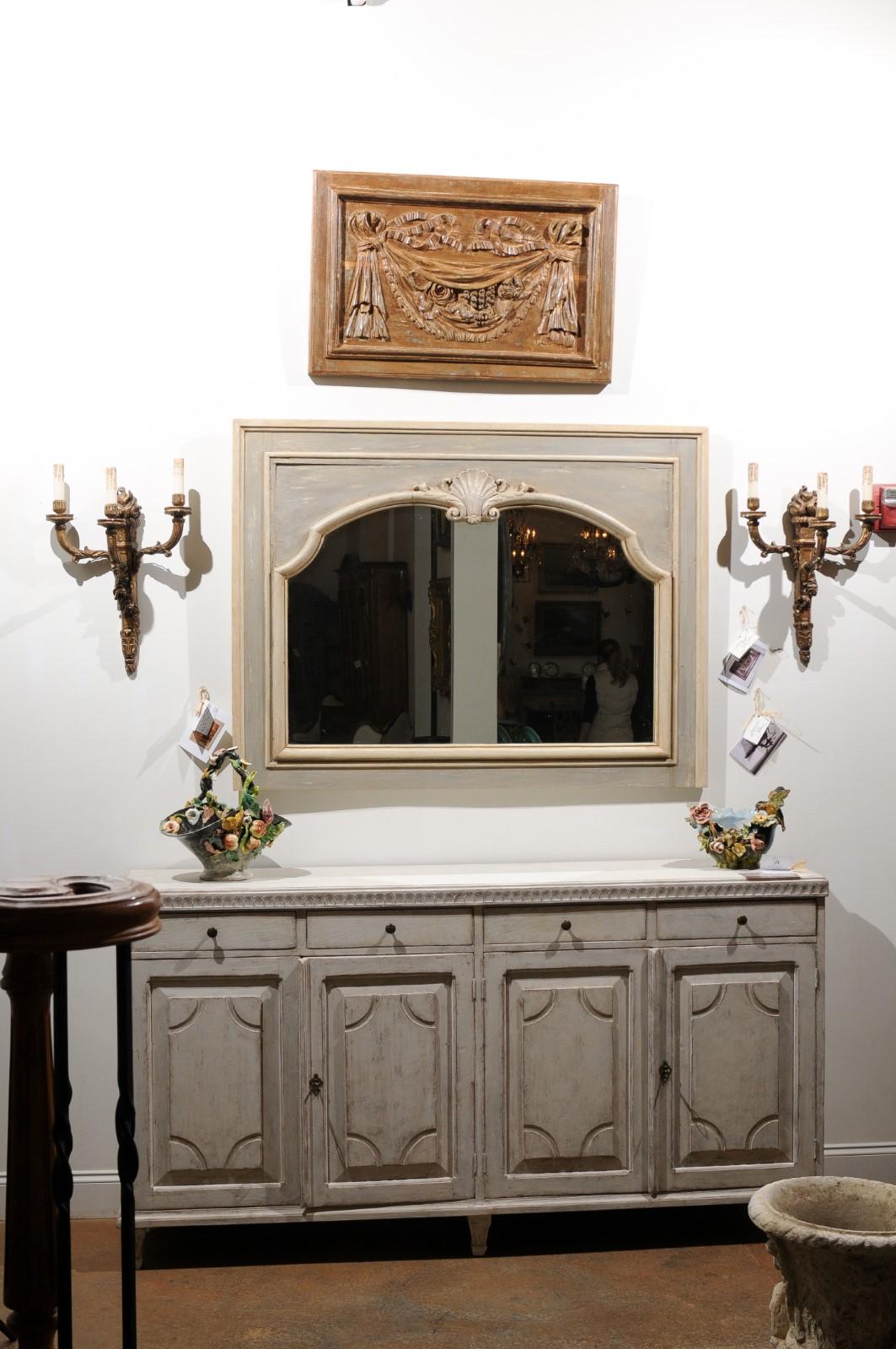 A pair of French hand carved wooden decorative panels from the 18th century, with ribbon-tied swags, flowers and fruits. Born in France during the Age of Enlightenment, each of this pair of wooden architectural panels features a swag, hand carved in
