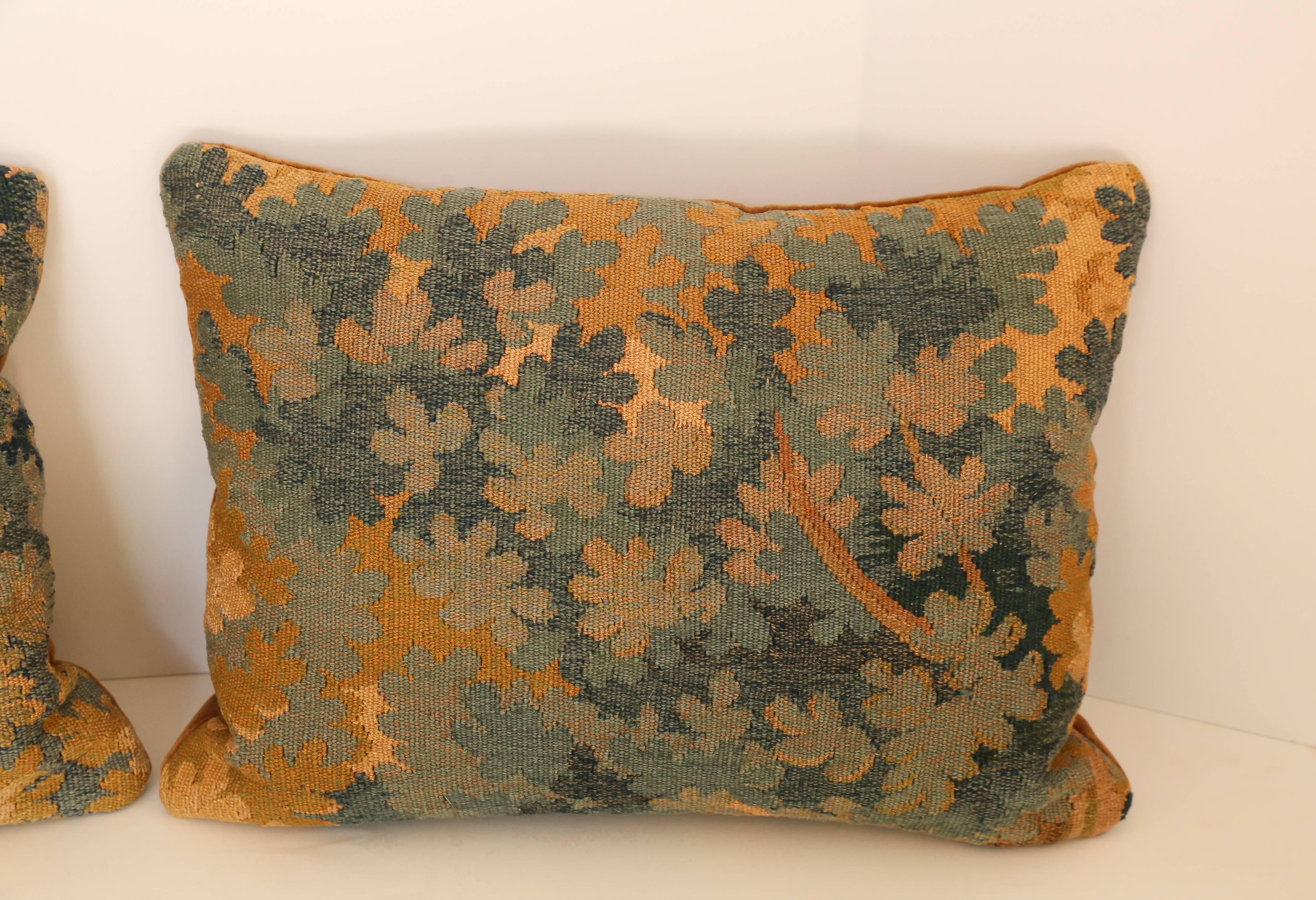 Pair of 18th century Aubusson pillows backed in velvet.
