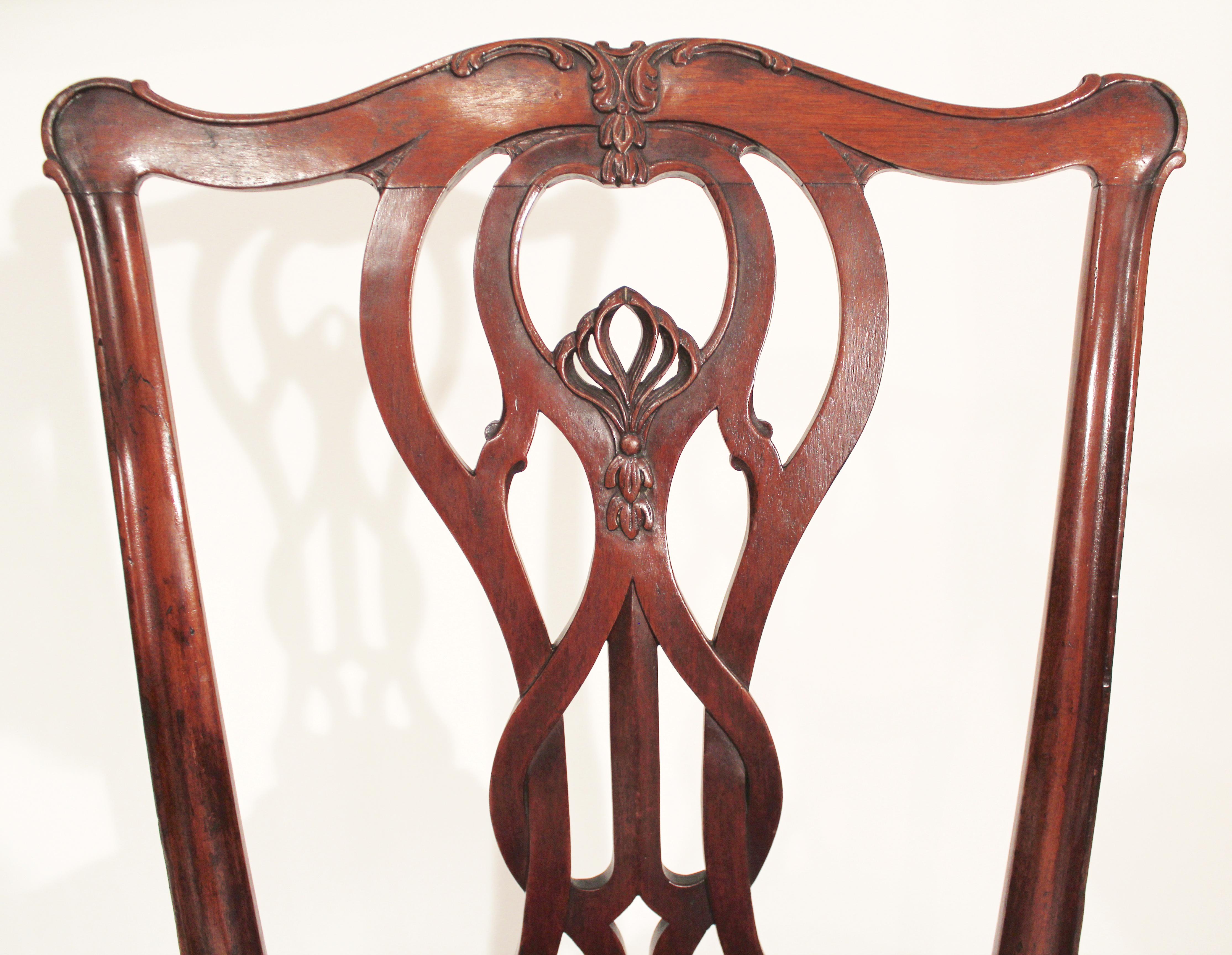 Pair of Baltimore mahogany Chippendale side chairs with wonderfully carved crest rail and pierced Gothic splat with molded stiles cabriole legs terminating in claw and ball feet.