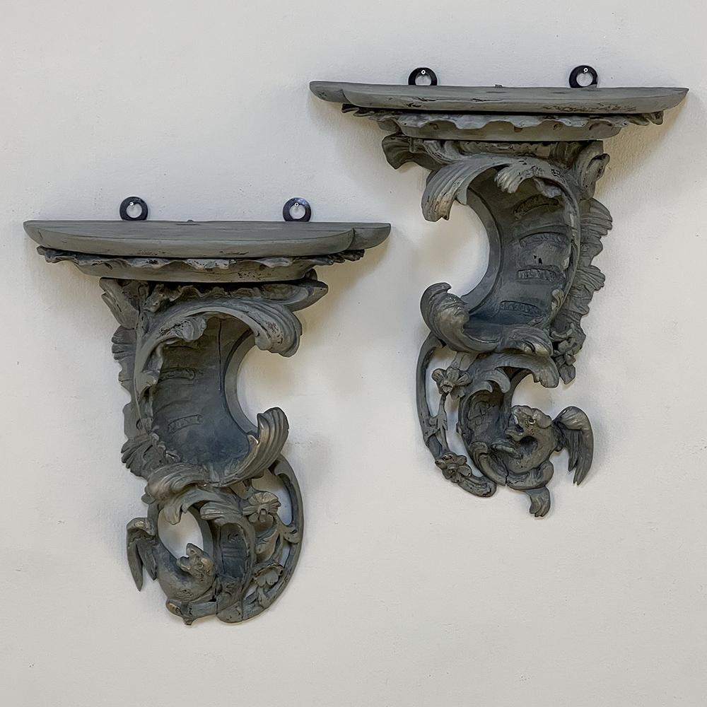 Pair 18th Century Rococo Period Painted Wall Sconces are remarkable works, celebrating the asymmetrical naturalism of the movement with stylized shell, acanthus foliage and wildflowers providing the primary subject matter of the sculpture.  Carved