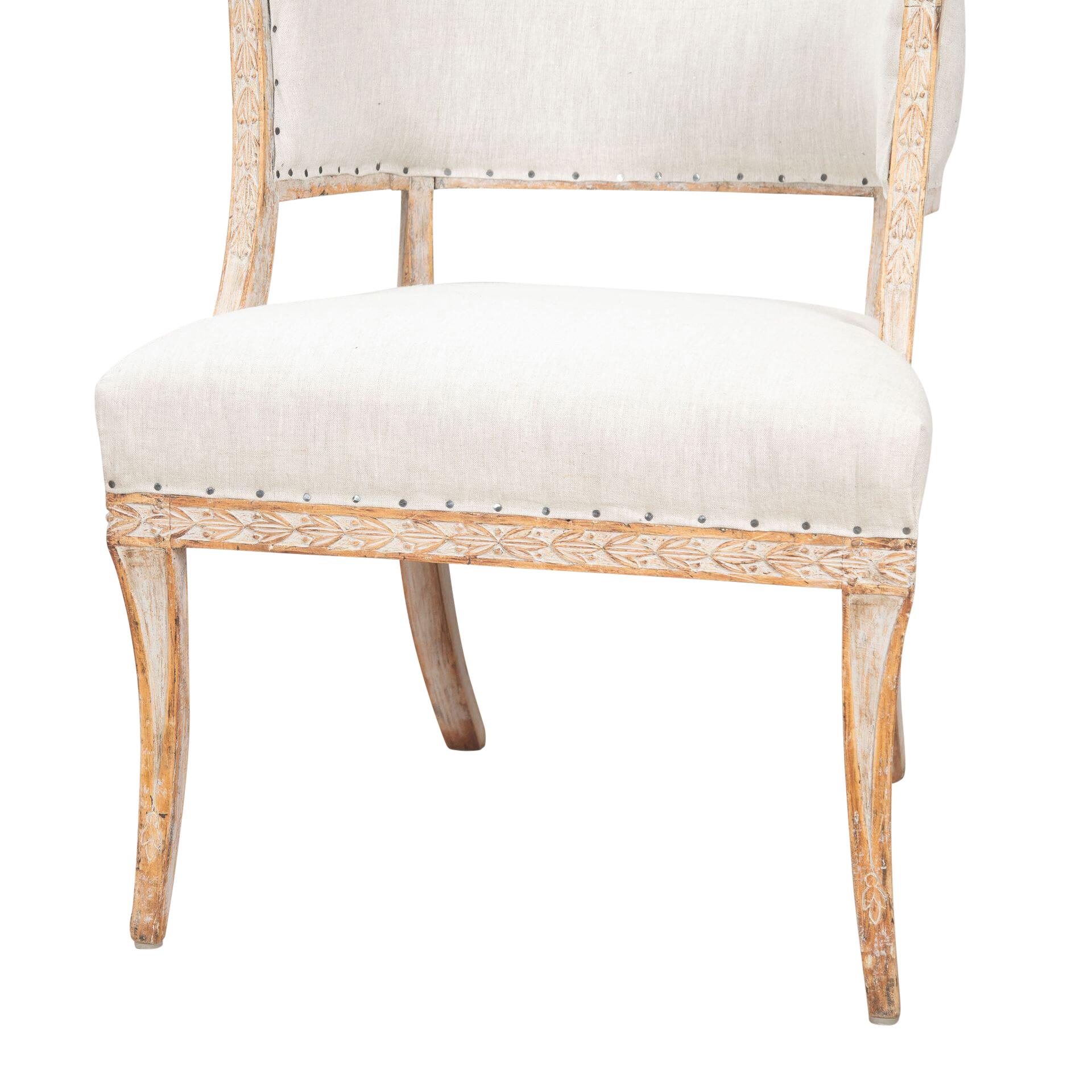 A pair of provincial barrel back chairs in a decorative carved design with stylish kick-out legs.
Repainted in soft grey with newly upholstered linen.
