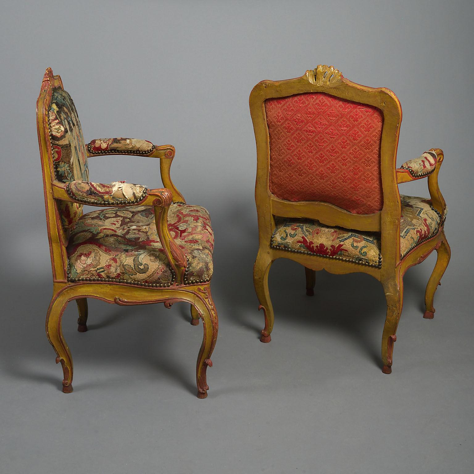 With stuffed cartouche-shaped backs, padded arms and stuffed seats all covered in associated(?) 18th century needlework, the frames and cabriole legs carved with Rococo scrollwork,painted decoration refreshed.