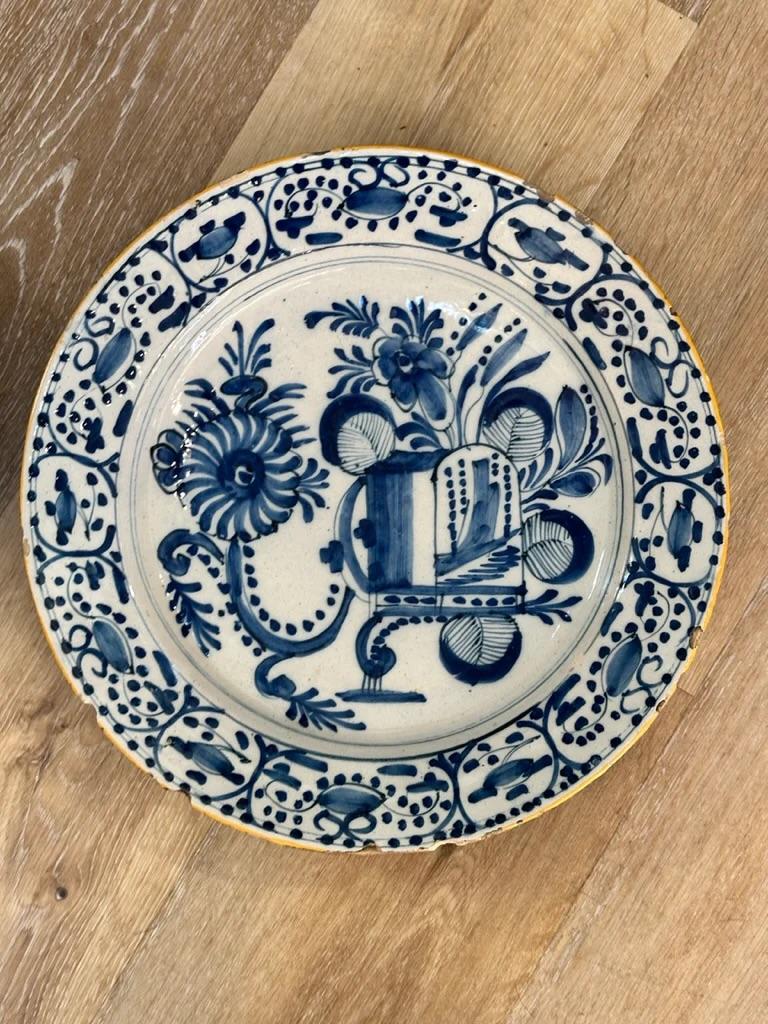 Rare pair of 18th Century Dutch Delft Chargers, stylized blue and white floral decoration with yellow rims.  13.74” diam, 2” h.