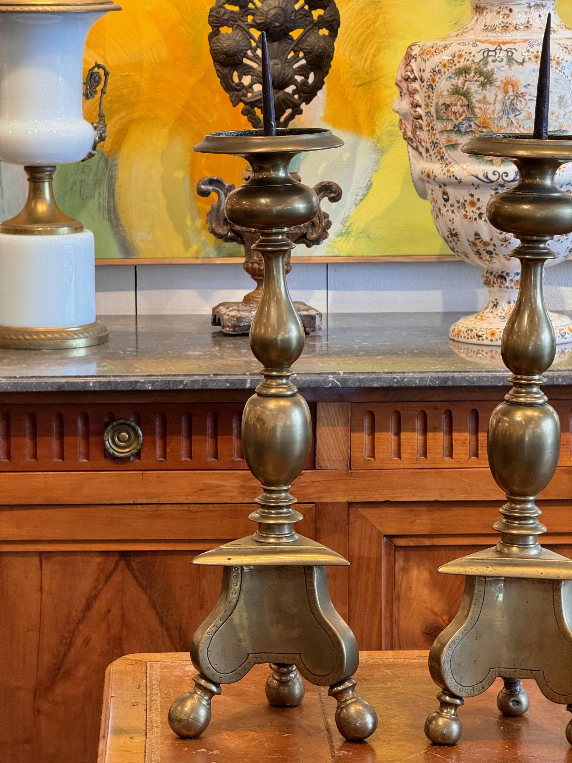 An early pair of heavy brass candlesticks. These are rare and will brighten any room.