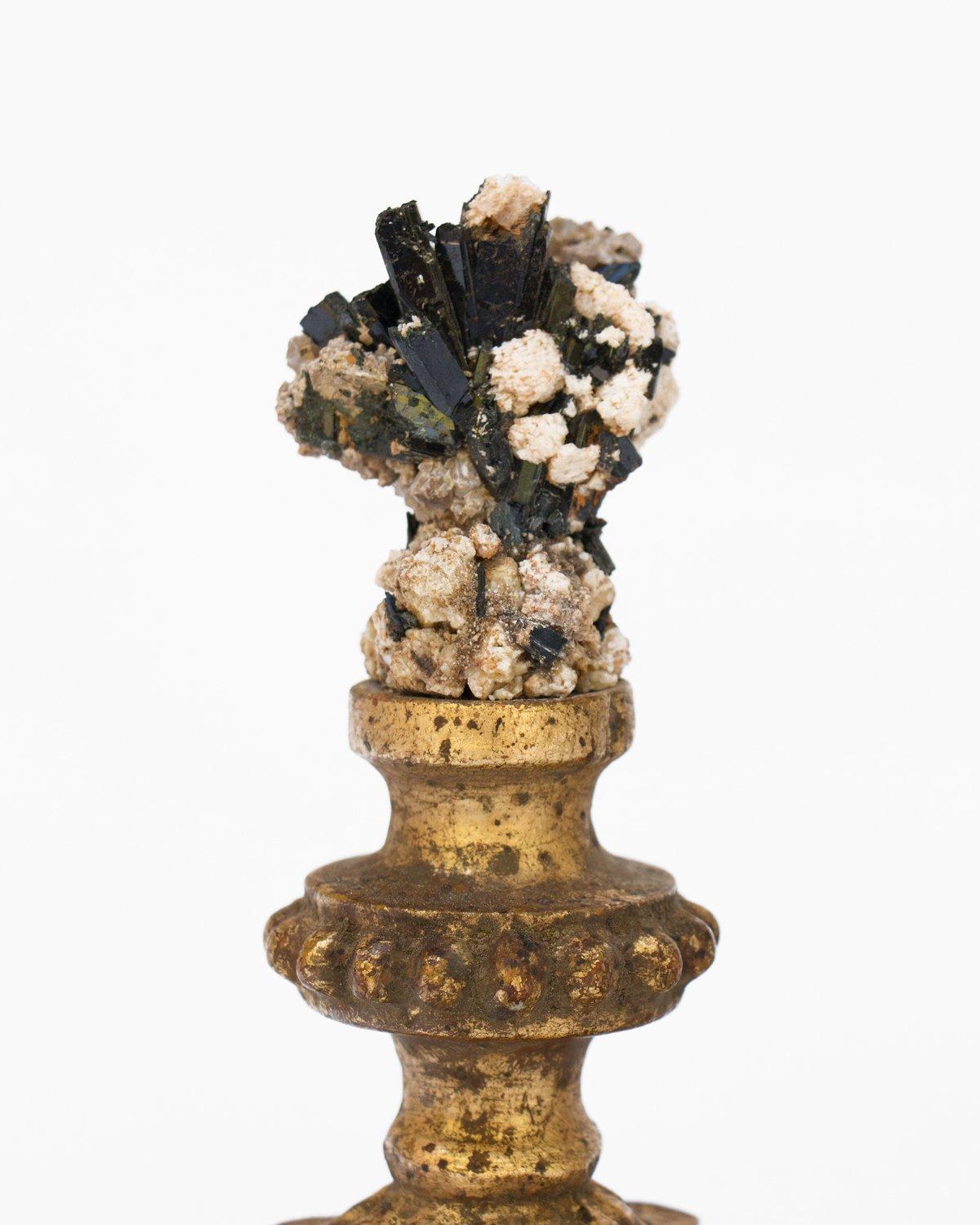 A pair of 18th century Italian candlestick fragments decorated with tourmaline in matrix.

The pair of 18th century Italian gold leaf candlestick fragments are originally from a church in Florence. They are combined with natural-forming toumaline.