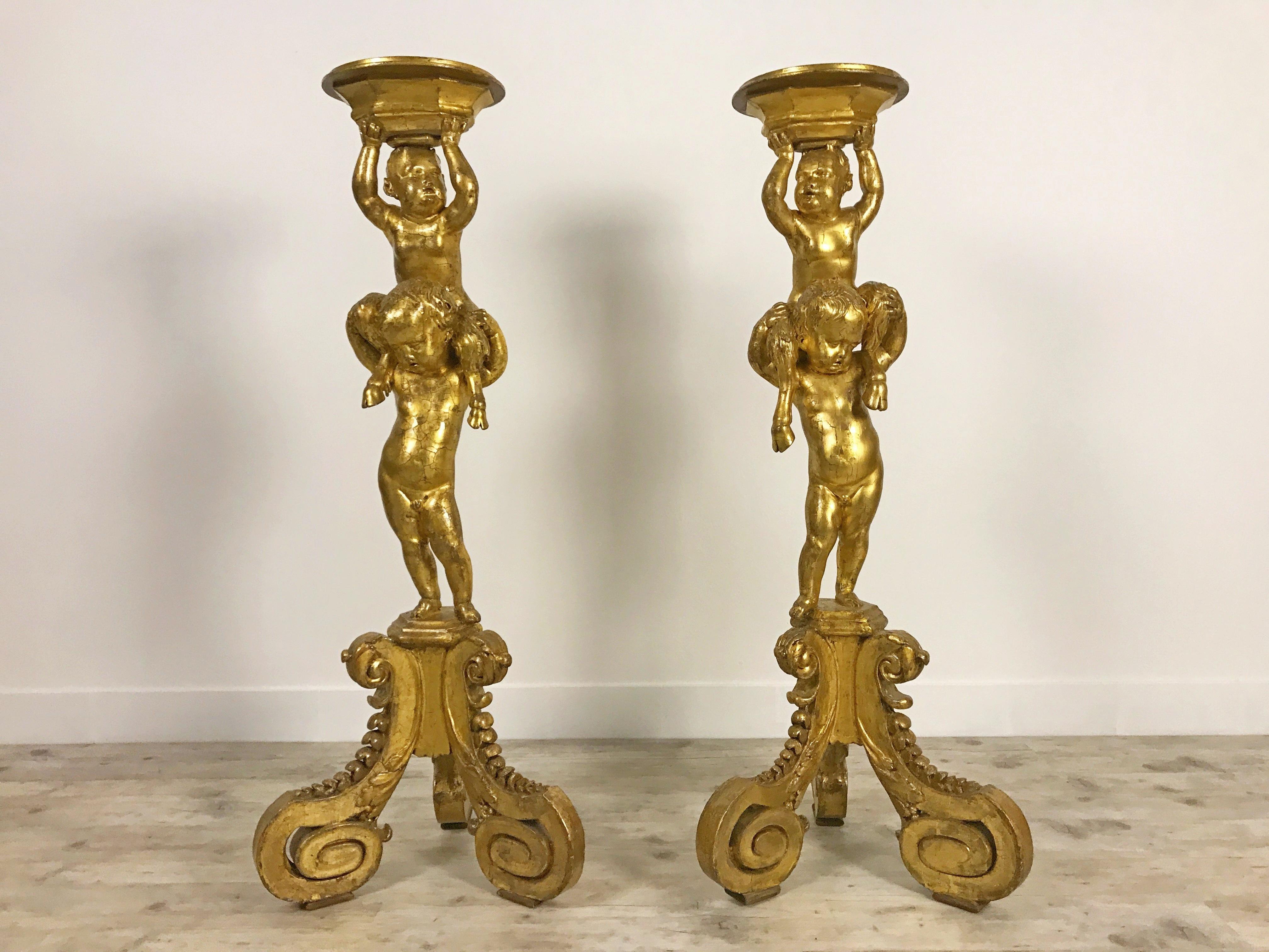 Pair of 18th century guéridons in carved and gilded wood.