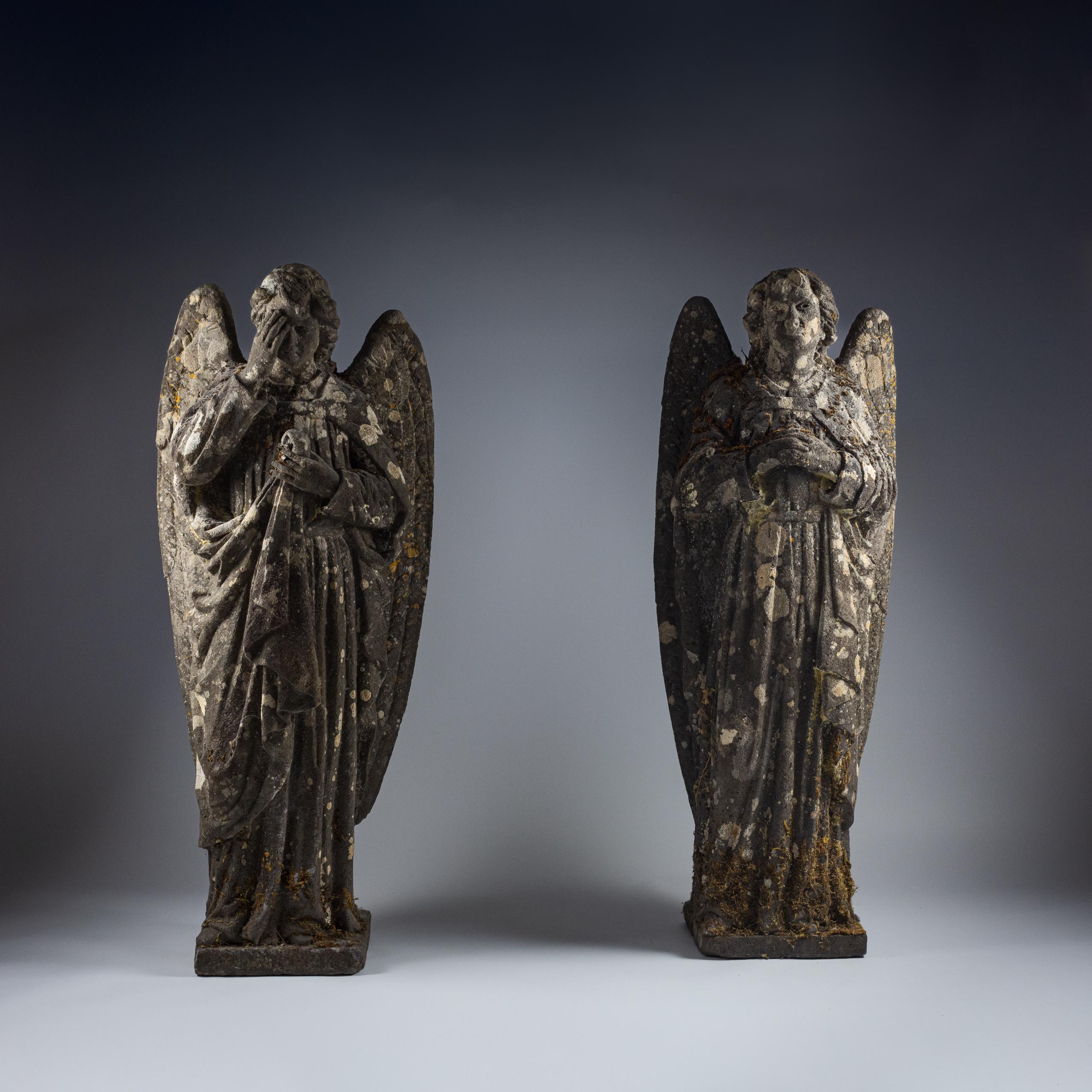 Truly remarkable pair of Carved Limestone Angels. Wonderful natural patination and lichen. Unusual pose, with one clasping her hands, whilst the other her right hand touching her forehead. Clearly carved by the same hand, and having weathered