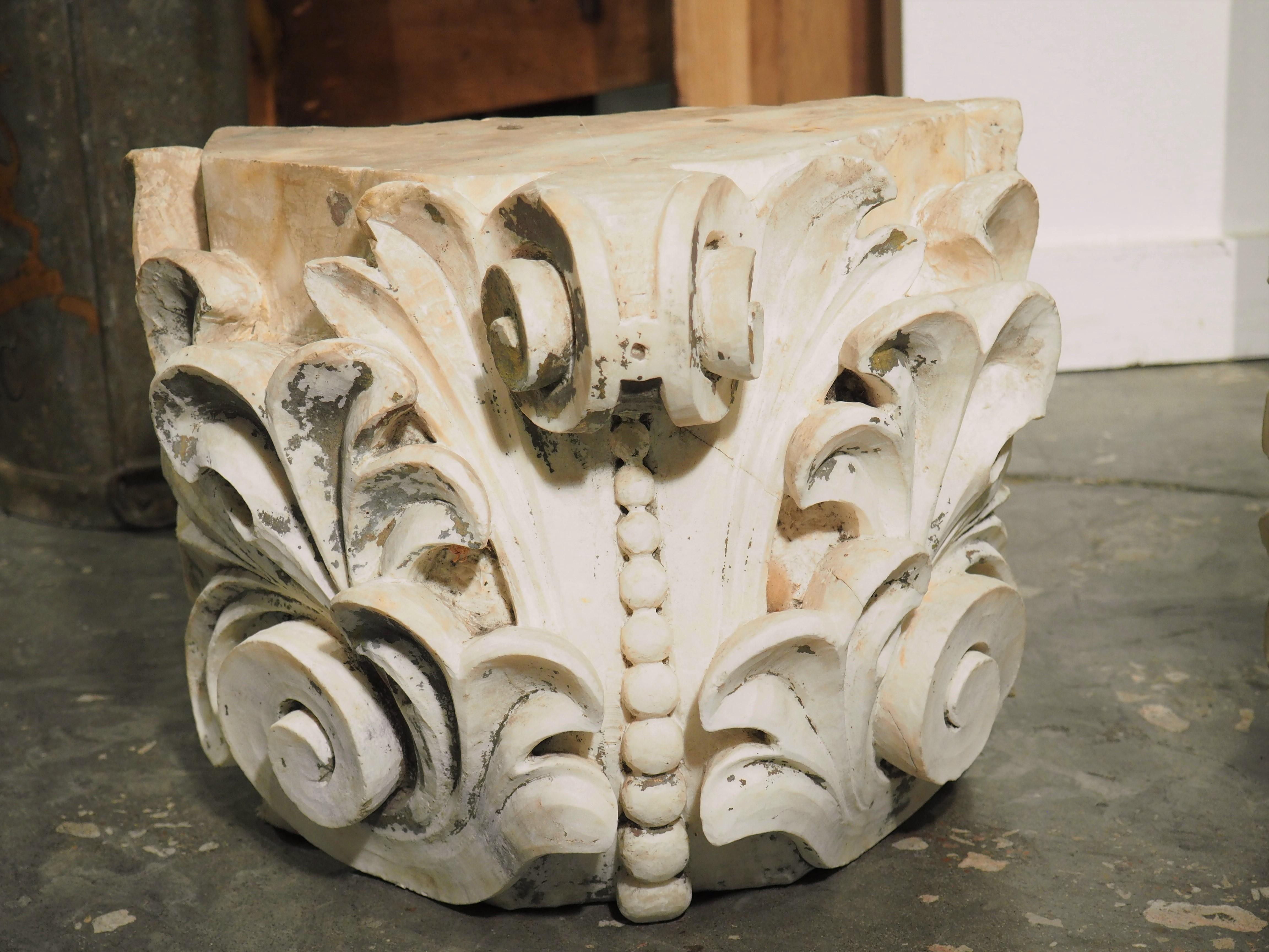Hand-carved by a master Italian mason in the 1700’s, this pair of marble capitals has elegant foliate carvings along five sides. The tops and bottoms have been polished, giving them a bright sheen. Both back sides have been left natural, revealing