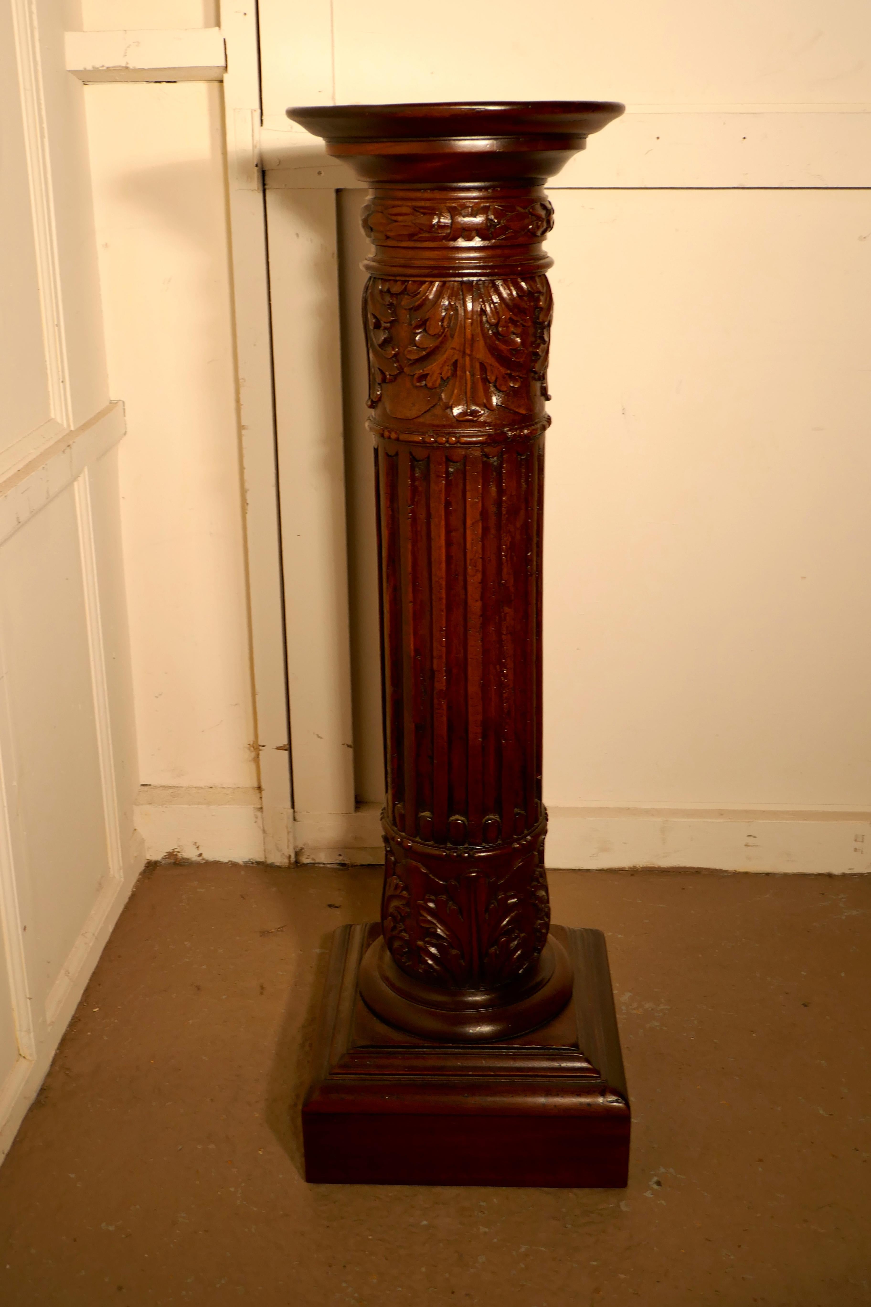 A pair of 18th century carved solid mahogany pedestals

These have been made from old columns, they are large, hefty pieces made in mahogany. The bases and the table tops are a 19th century modification
The columns have elaborate acanthus leaf