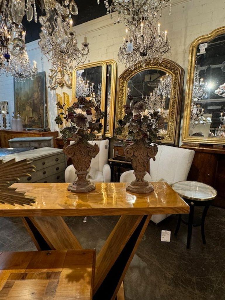 Decorative pair of 18th century carved wood topiaries with painted metal flowers. Gorgeous carvings on these. A great accessory!! Circa 1760.
26h x 14w