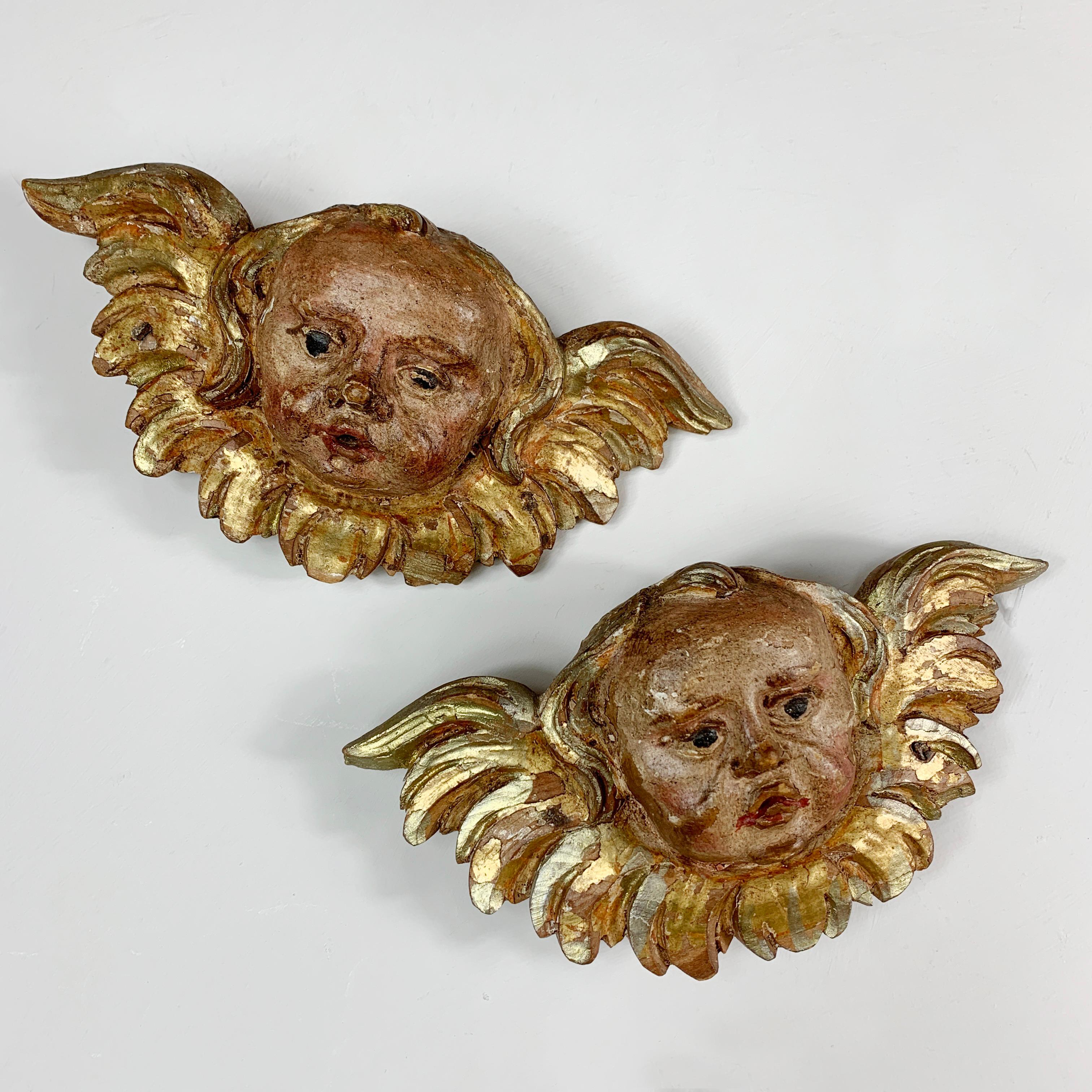 A superb pair of early 1700’s German Baroque putti, hand carved in wood with a thin layer of gesso, and painted in polychrome and gilt, these originally adorned the walls of a cathedral, the original nails that held them in place are still embedded
