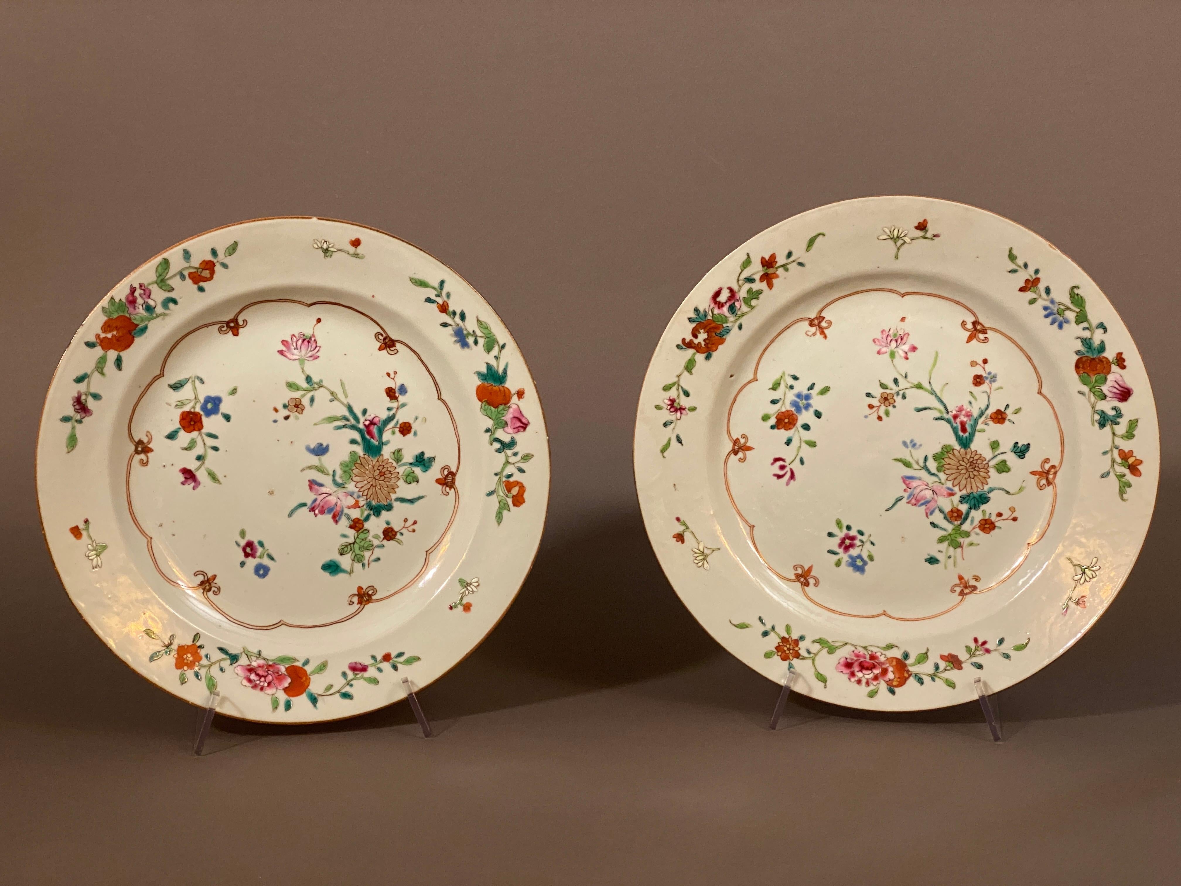 Paire d'assiettes en porcelaine famille rose de la Compagnie des Indes orientales du XVIIIe siècle, à décor polychrome et doré de fleurs et de chrysanthèmes.

Légère usure de l'émail. L'un d'eux présente un très petit éclat sur le bord arrière qui
