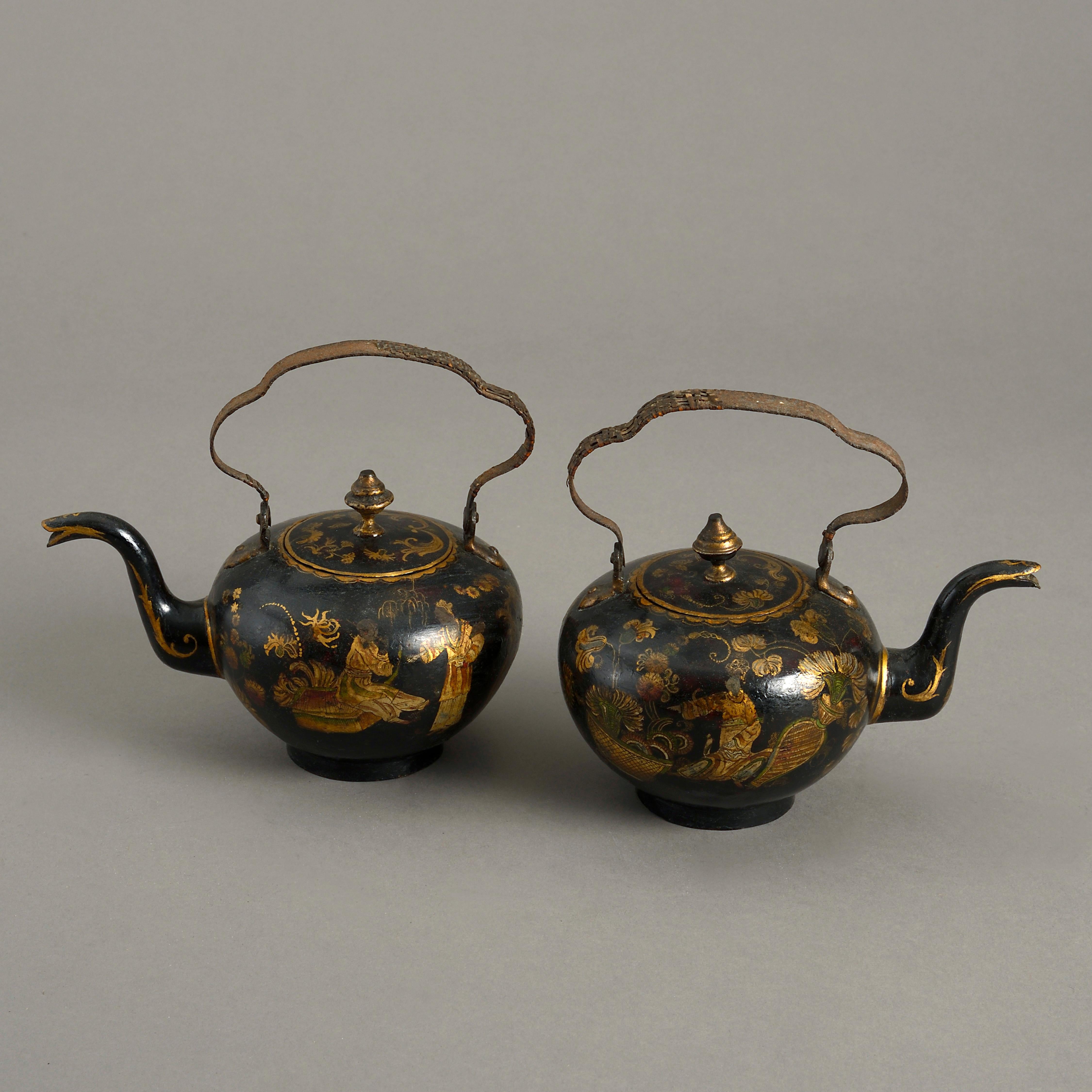 A rare pair of late 18th century Chinoiserie japanned tole teapots, having bamboo handles, the lids and bodies decorated with gilded figures and foliage upon a black ground.