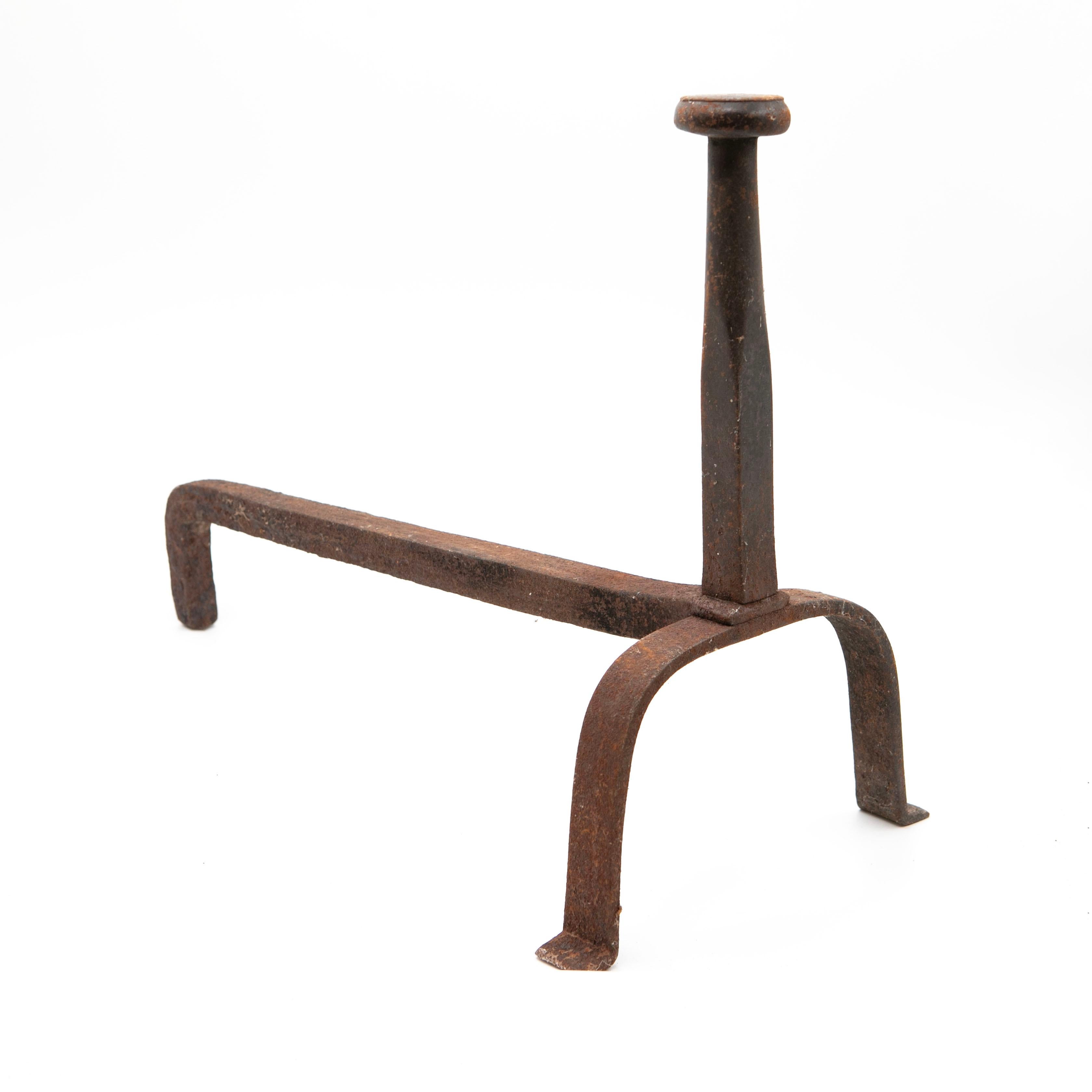 A pair of Baroque andirons crafted in wrought iron.

These fireplace supports feature a striking and timeless design, with a naturally aged patina that highlights their age and character.

In excellent condition with a cool, age-related