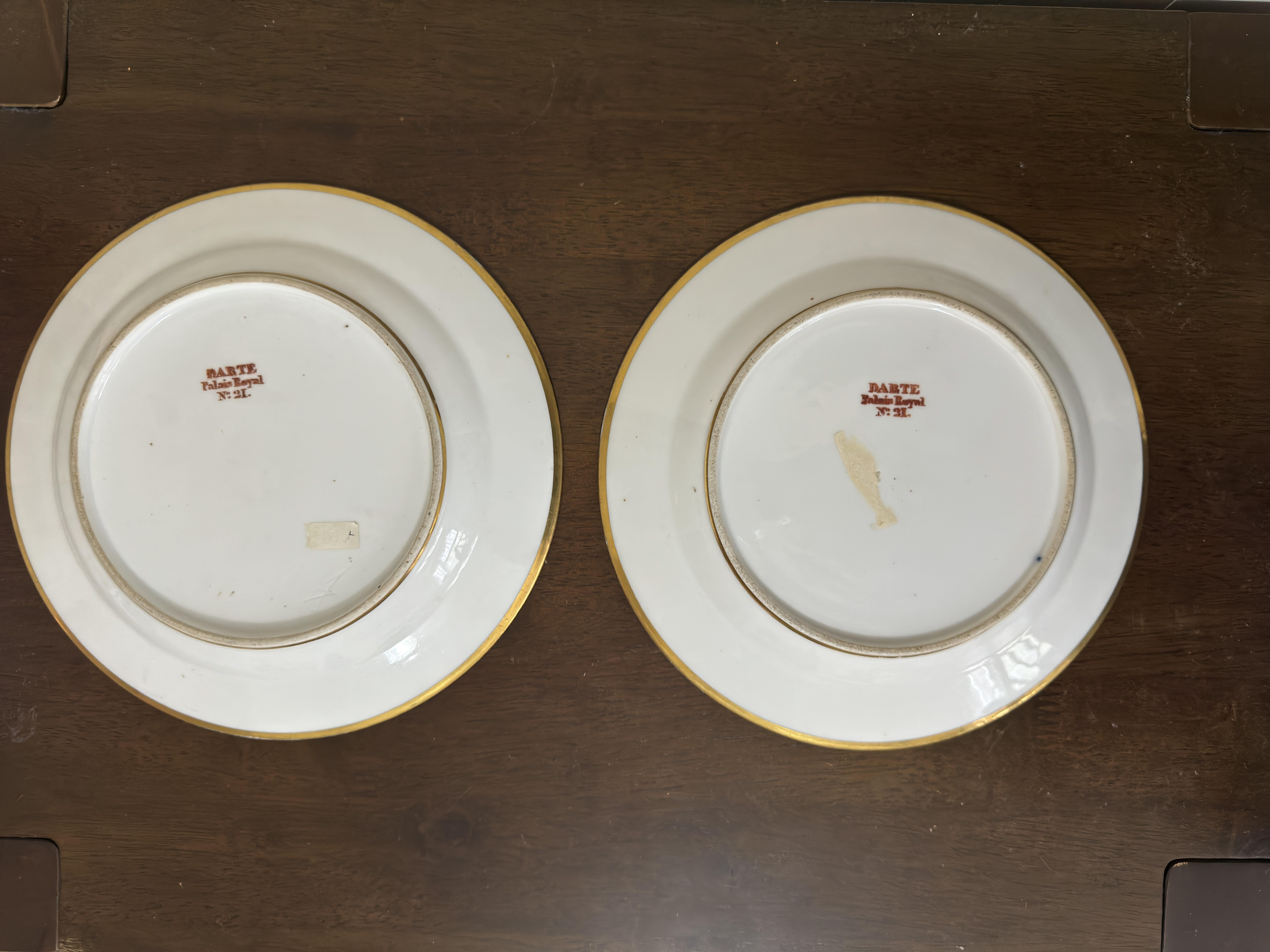 Pair of antique Darte Brothers cobalt blue porcelain plates magnificently painted with the French countryside, featuring cows, goats and sheep, decorated with gold rims. Each with the original Darte Brothers Palais Royal signature mark in red ink.