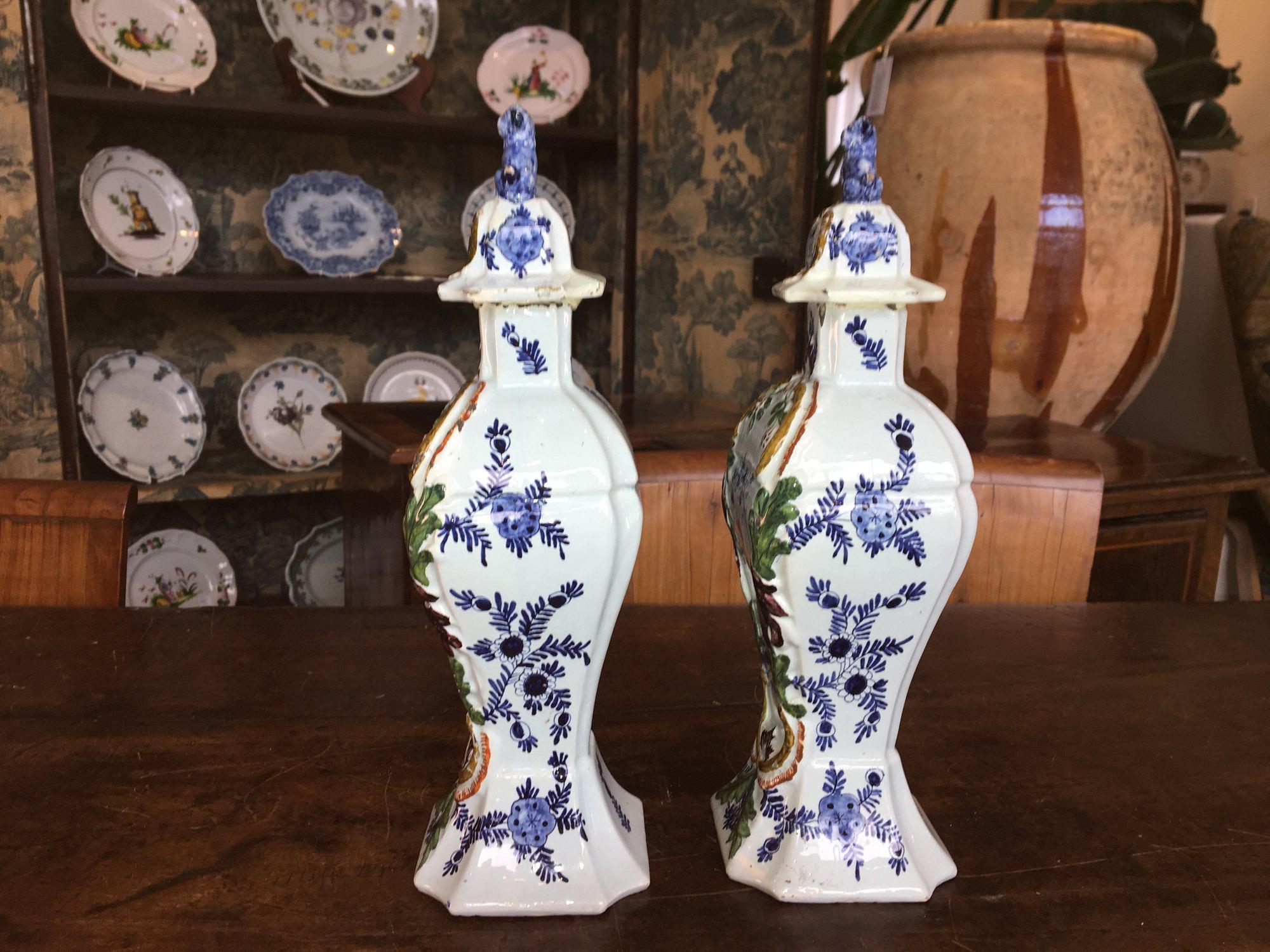 Pair of 18th century delft jars, chinoiserie décor with foo dog lids, some early restoration. In excellent condition. Marked Jacobus Harlees, circa 1770, de Porcelain Fles Factory.
