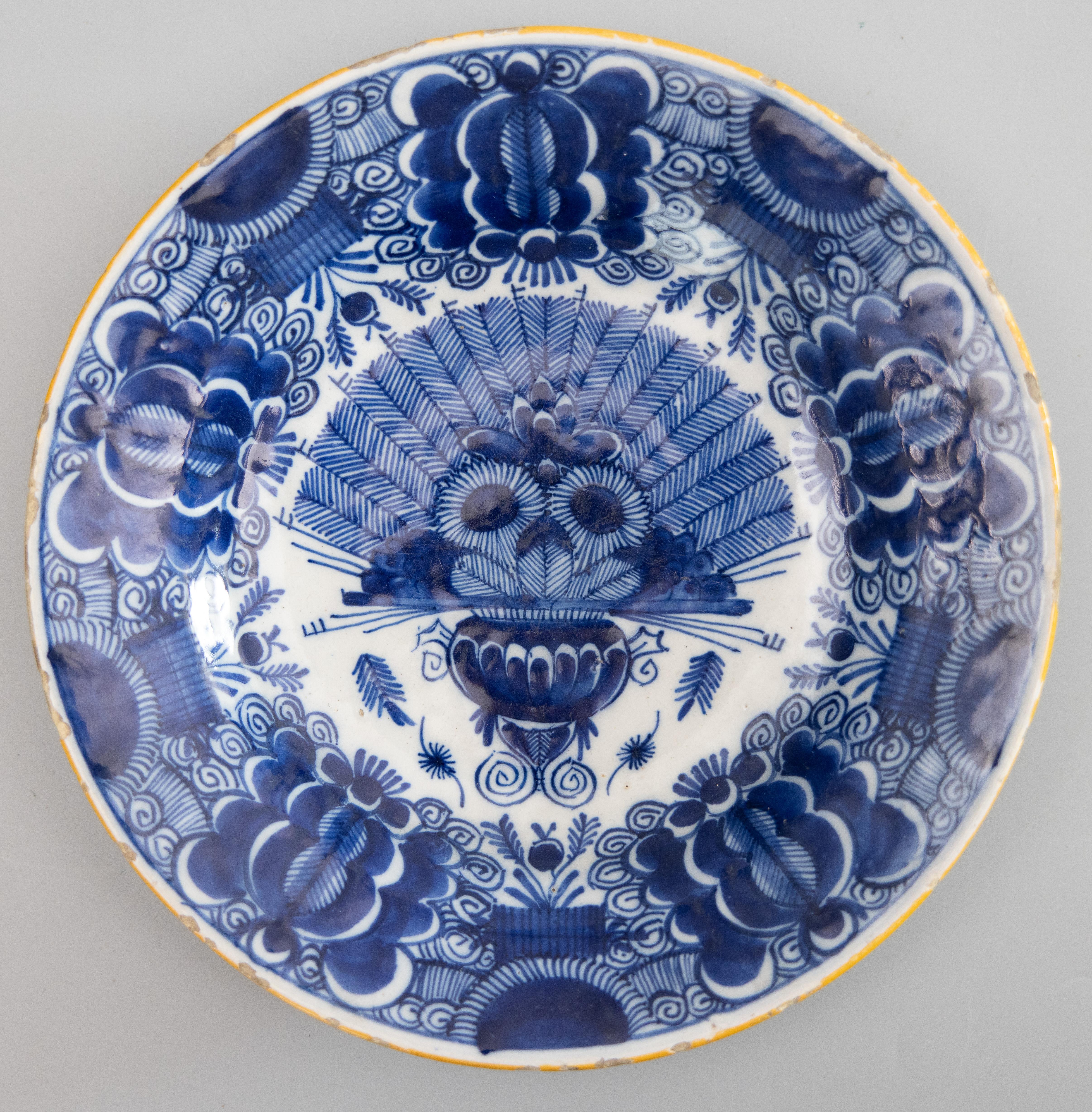 A superb antique pair of 18th-Century Dutch Delft faience plates with the 'Peacock' pattern by the De Klaauw (The Claw) Delftware factory. Maker's mark on reverse. These lovely plates have a hand painted peacock design in cobalt blue and white with