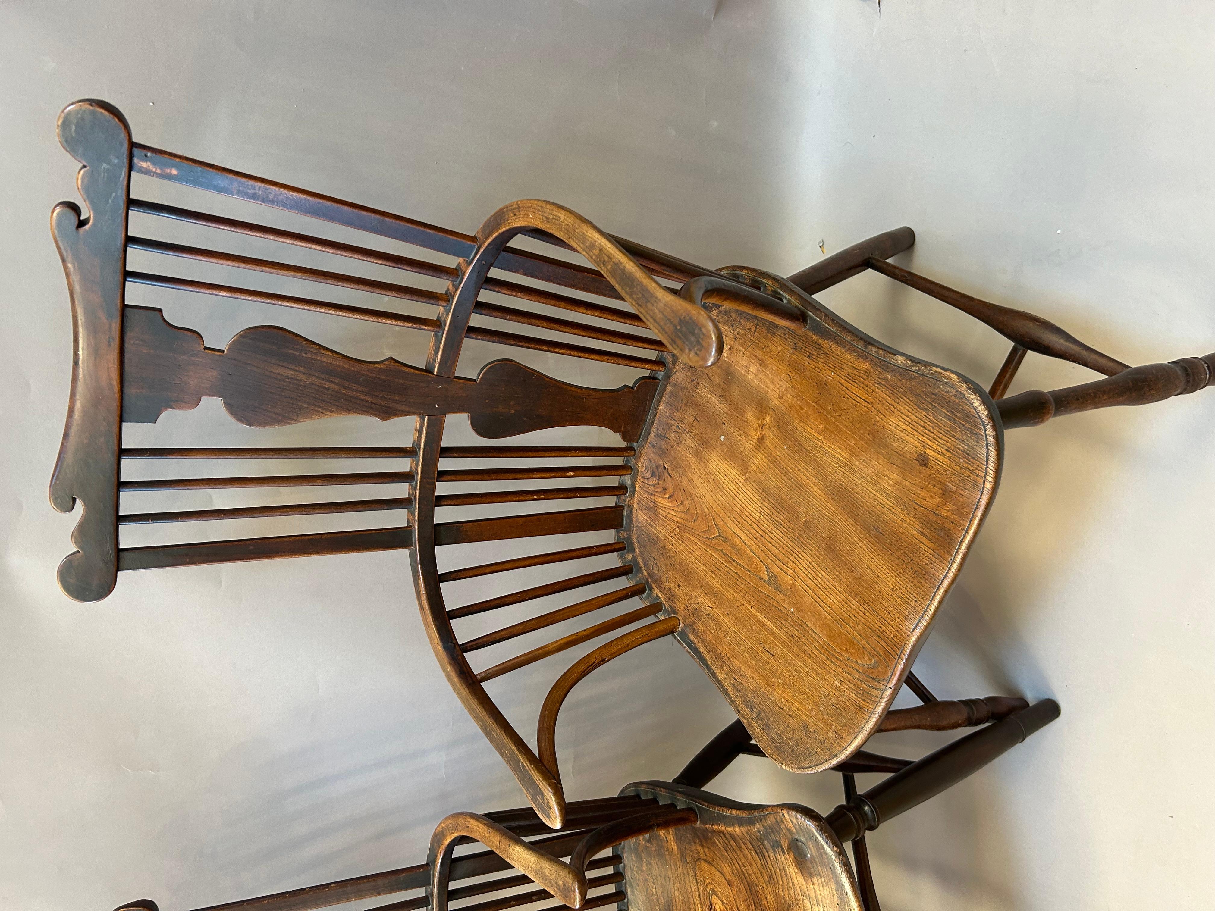 Extremely Rare Pair of 18th Century English Comb Back Windsor Armchairs. Shaped comb top rail over central splat with bowed arms  over shaped figured elm seats and delicate turned legs. A mixture of elm, ash and walnut with a rich lustrous