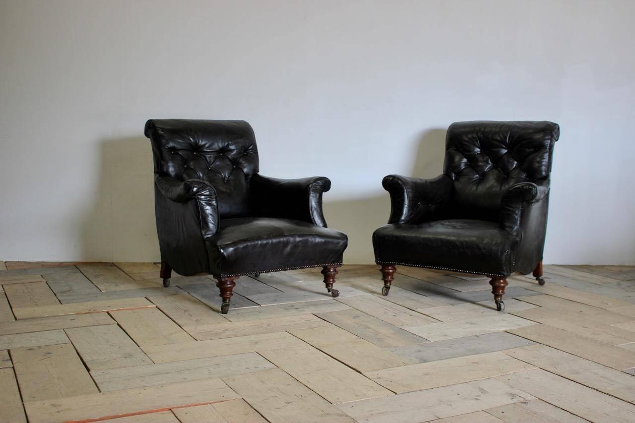 A very comfortable and of great design, pair of 19th century English library armchairs retaining the original leather (with some restorations), that will work well in most settings.