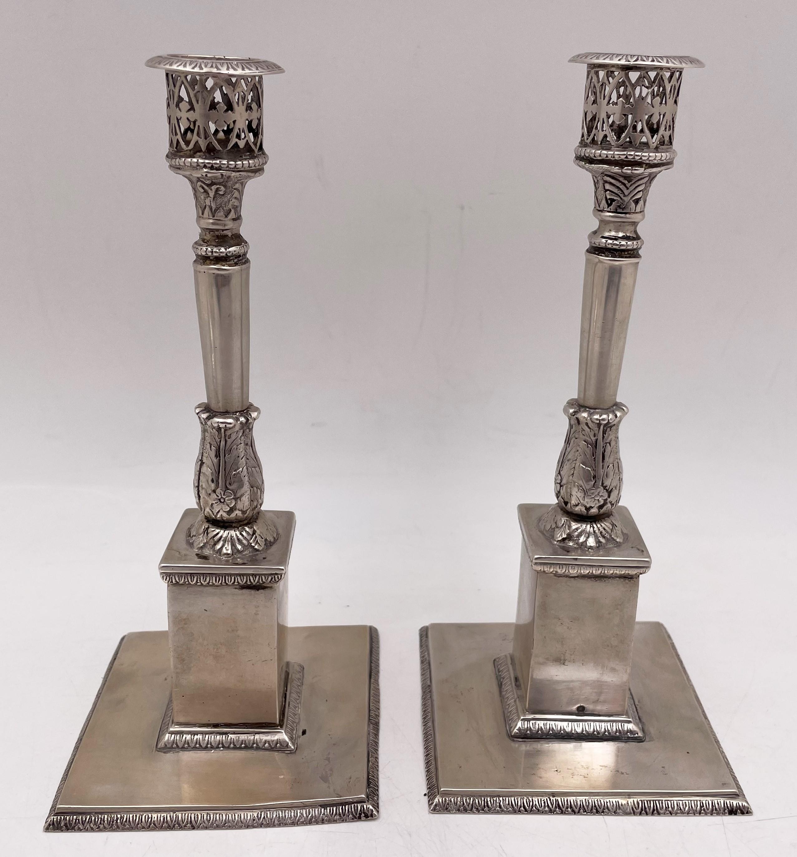 Pair of 18th century silver candlesticks, either Dutch or German, with an elegant design, standing on a square base, with stylized motifs, including palmettes, measuring 8'' in height by 3 5/8'' in depth, and bearing hallmarks as shown. 

Please