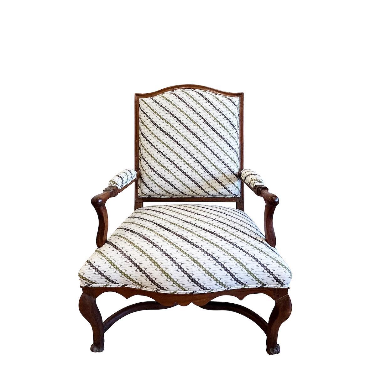 Discovered in the South of France and newly upholstered in our Ronnie fabric, these 18th-century fauteuils have the elegant silhouettes and stately proportions associated with Louis XIV. Comfortable and commodious, with beautiful carved walnut