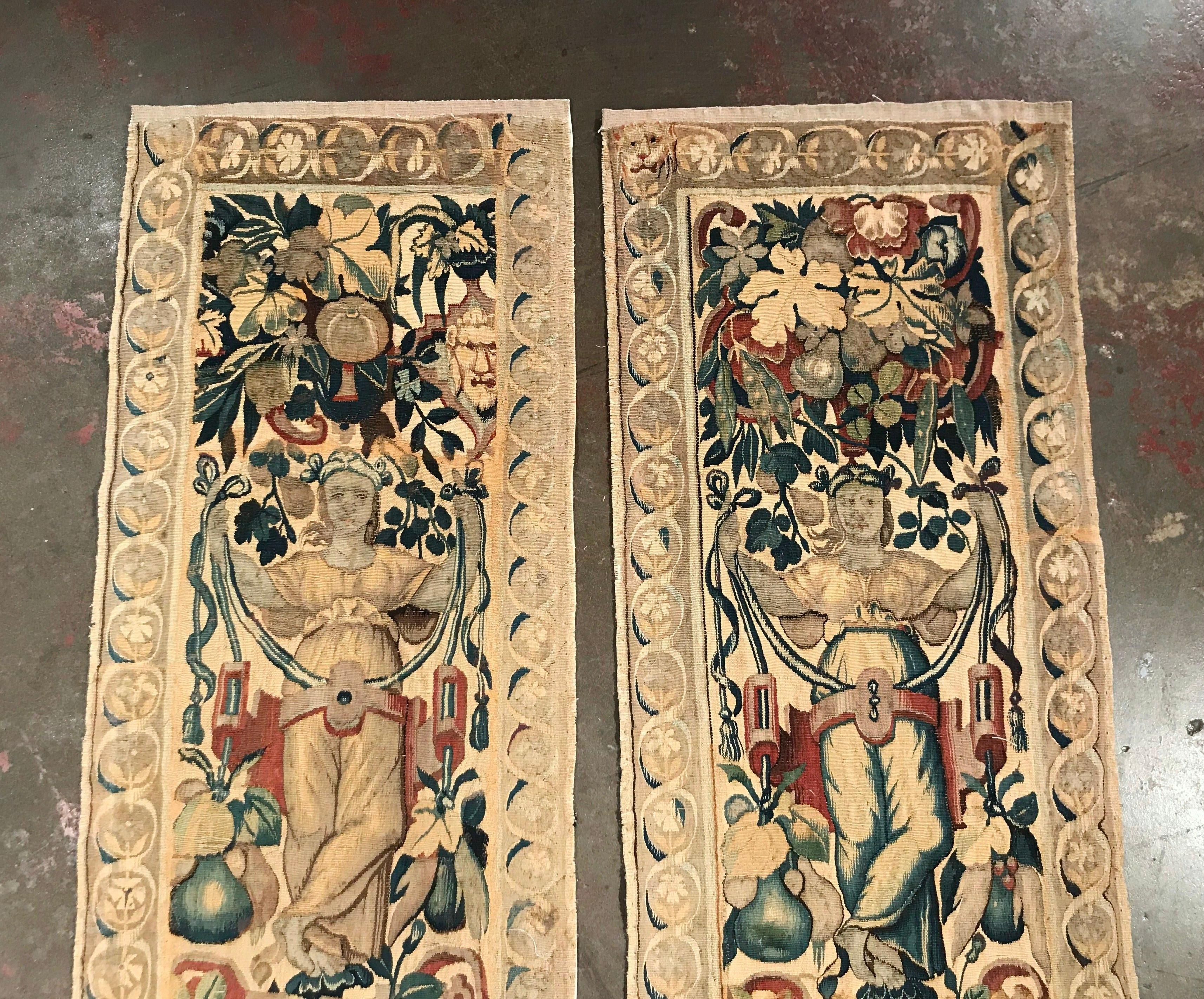 Called portieres, these antique wall hanging tapestries were handwoven in Belgium, circa 1760. They both feature mythological and lion figures flanked by foliage decor in the blue and green palette. Both pieces have a beige border with geometric