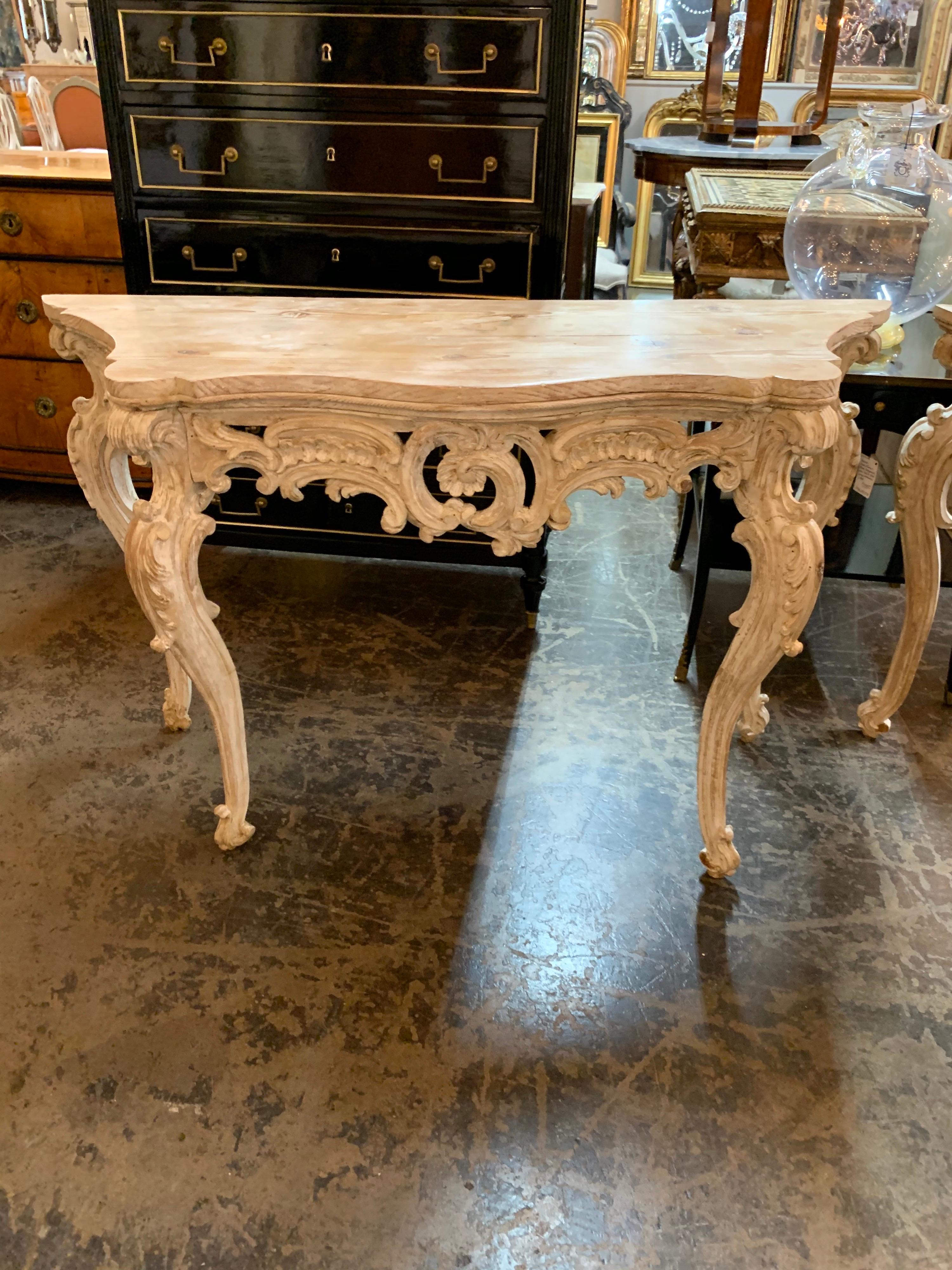 Amazing pair of 18th century French carved pine and gesso Louis XV style consoles. Very fine carving on this pair. Bleached look goes well with a variety of decors. So pretty!