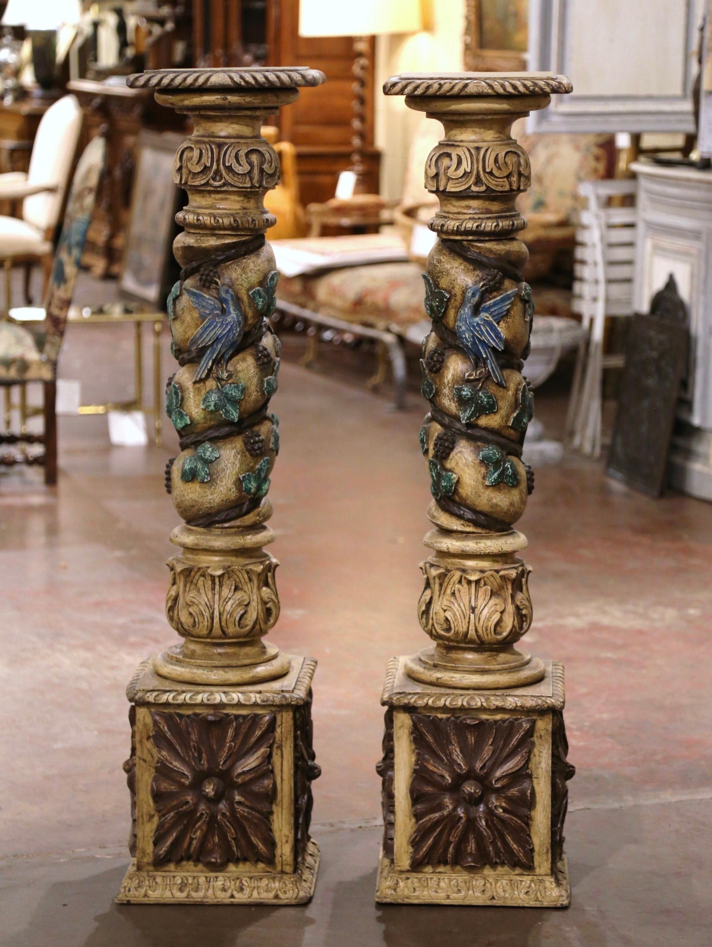 Decorate your wine cellar with these antique, carved columns. Hand carved in France, circa 1750, the tall painted carvings stand on a sturdy square base at the bottom and feature a rounded plate at the top to hold any interesting object. Each
