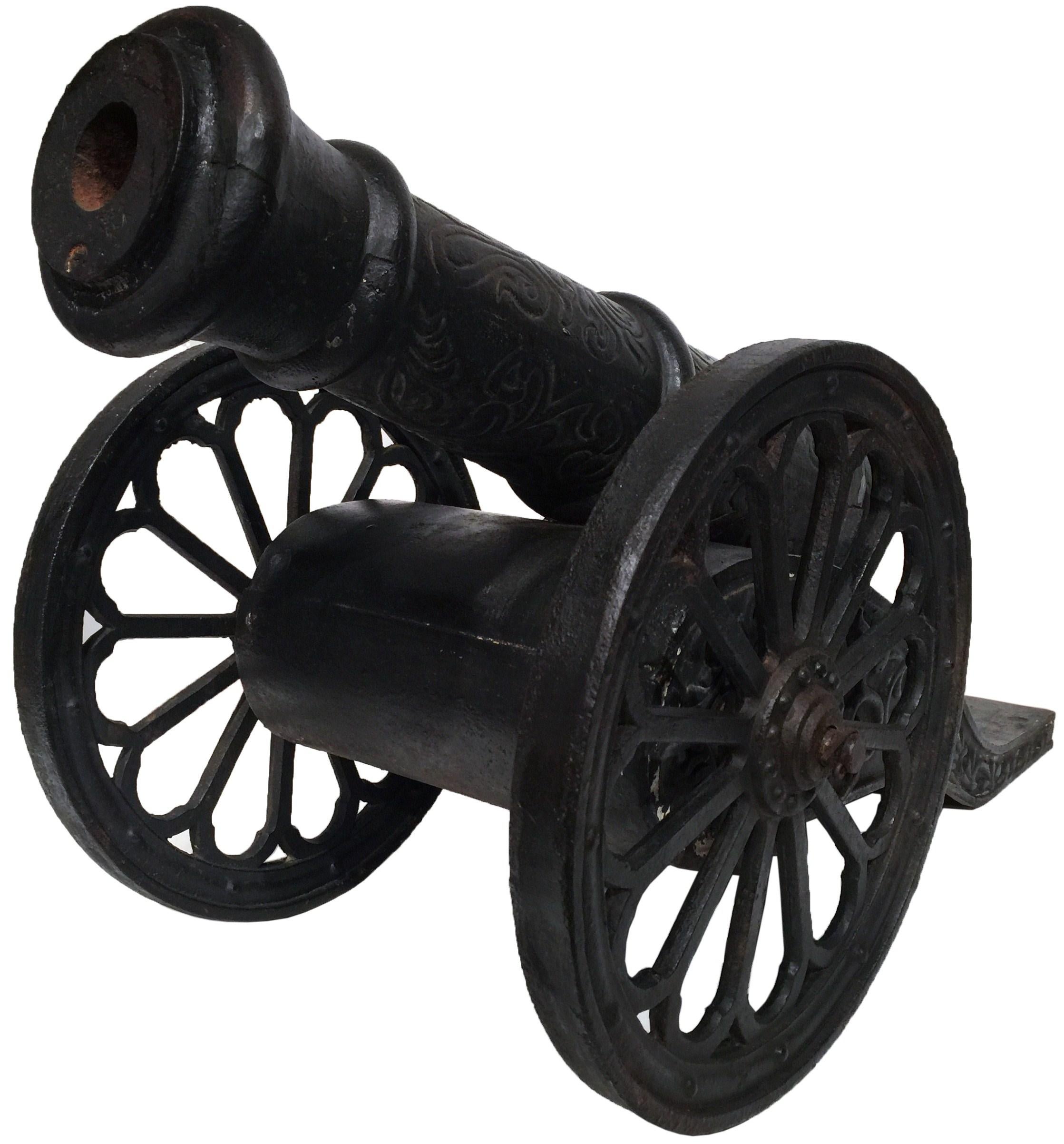 These iron cannons were forged France, circa 1800. The heavy, impressive decorative pieces are in the shape of artillery weapons and are set on wheels for easy mobility. The forged sculptures came from a large chateau in the South of France, and