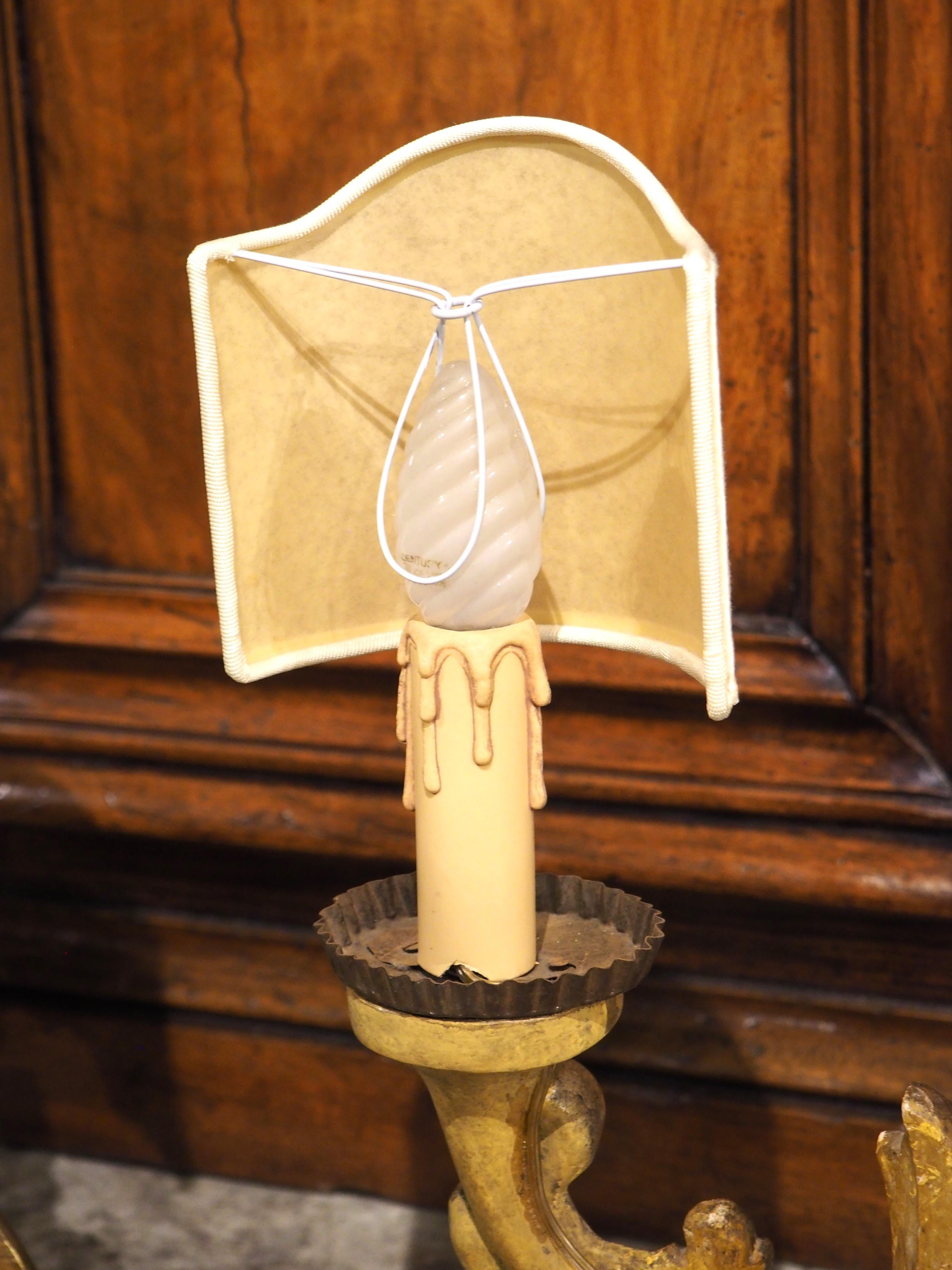 A beautiful pair of French lamps, with a gold leaf finish and a monogrammed cartouche. Originally hand-carved in the 1700s, the original function was most likely as three-light table candelabras, as indicated by the rectangular plinth that supports