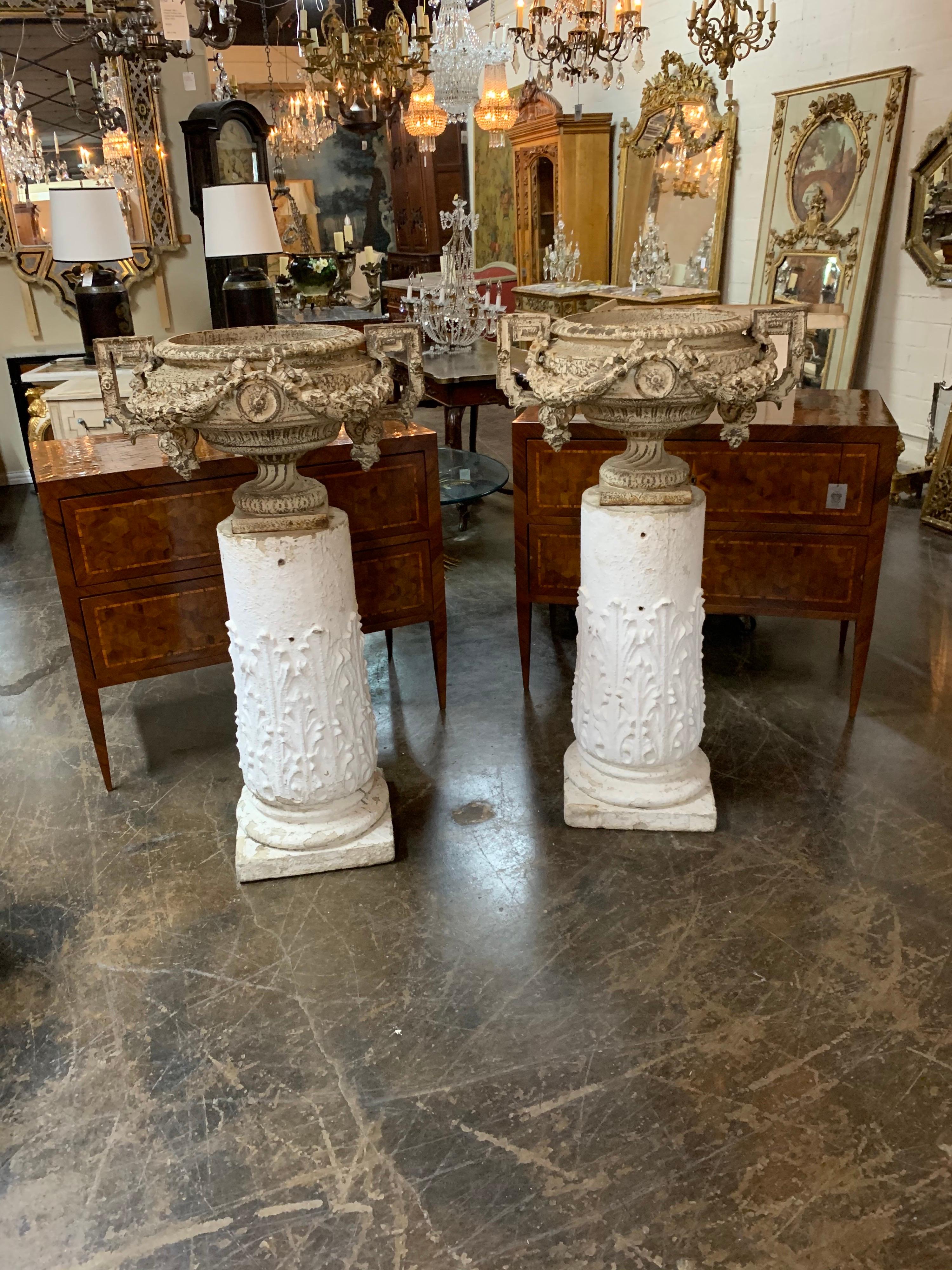 Fine pair of 18th century French iron garden urns on gesso pedestal bases. Ample size on the urns would make for a substantial planting. So pretty!