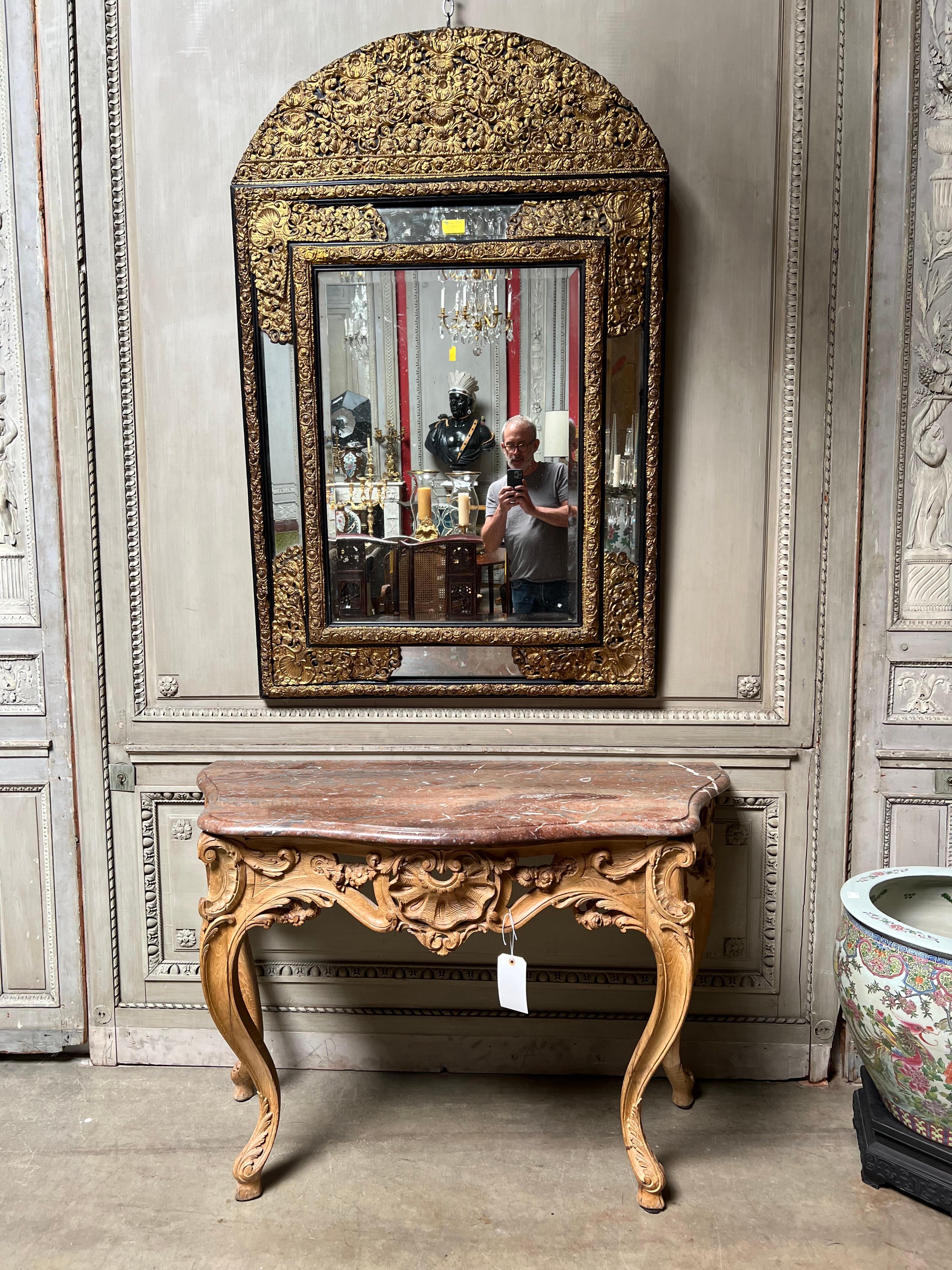 A pair of French carved wood Louis XV console tables with marble tops.  This fine pair of consoles are very nicely carved a wonderful medium sized scale and a warm wood patina.  